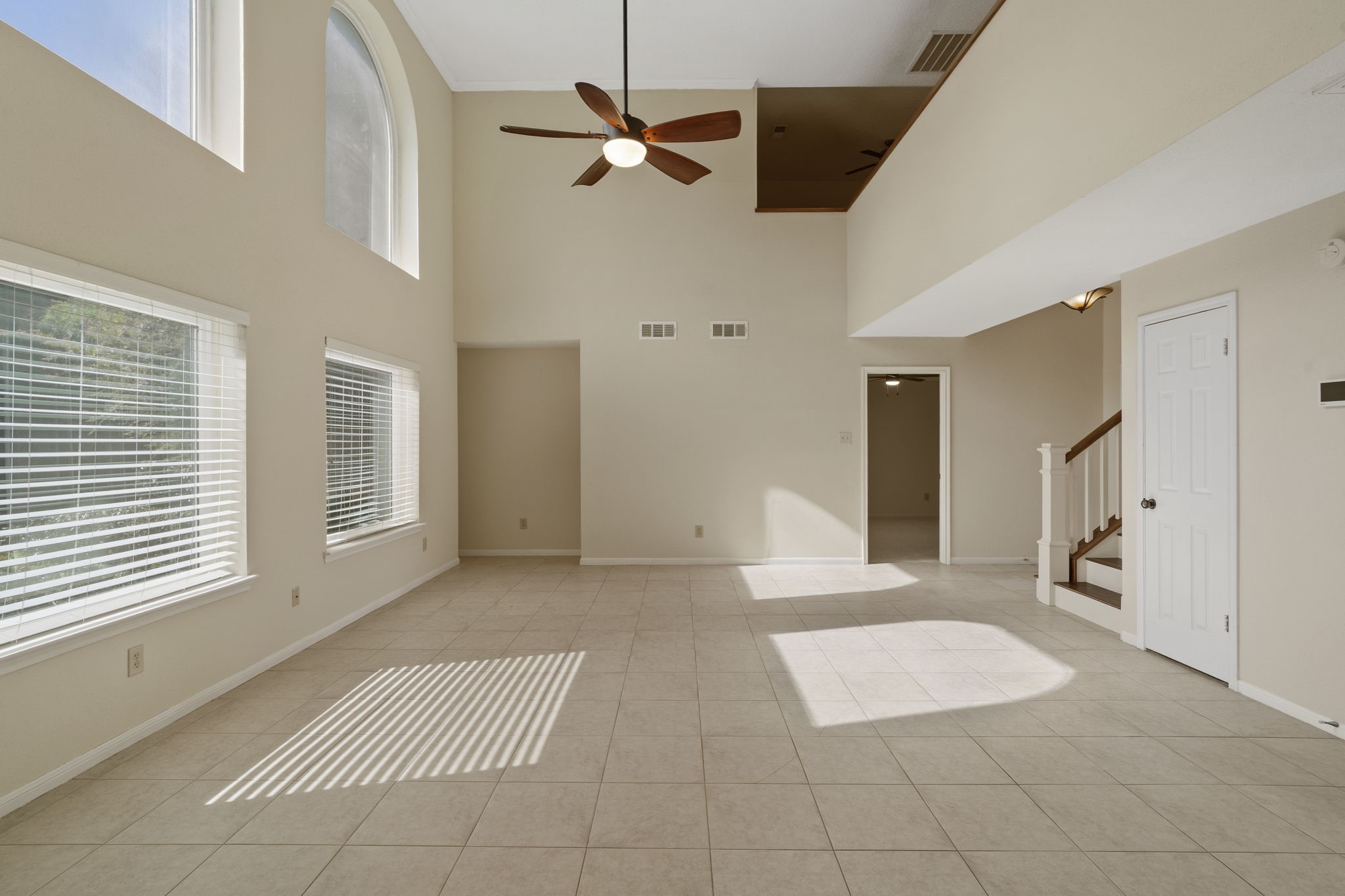 Dramatic two-story windows fill the family room with natural light. Dramatic two-story windows fill the family room with natural light.