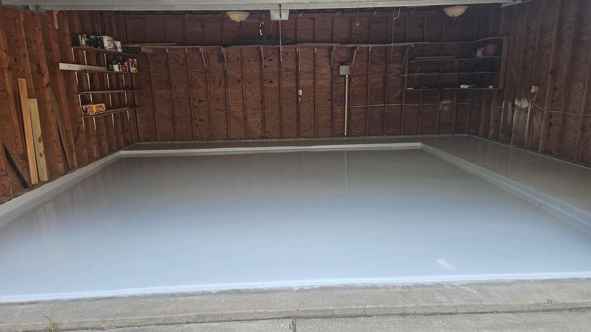 Garage floor has professionally installed epoxy coating.