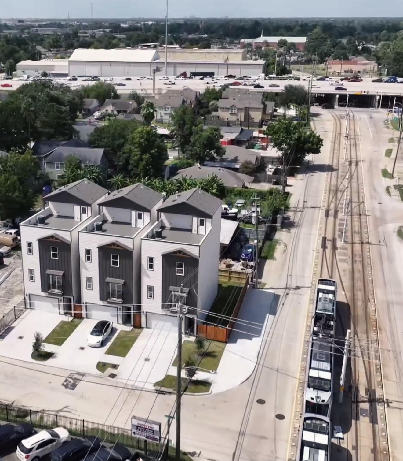 Modern townhomes with sleek designs, each featuring a private driveway and small yard, conveniently located near a light rail line for easy commuting. Modern townhomes with sleek designs, each featuring a private driveway and small yard, conveniently located near a light rail line for easy commuting.