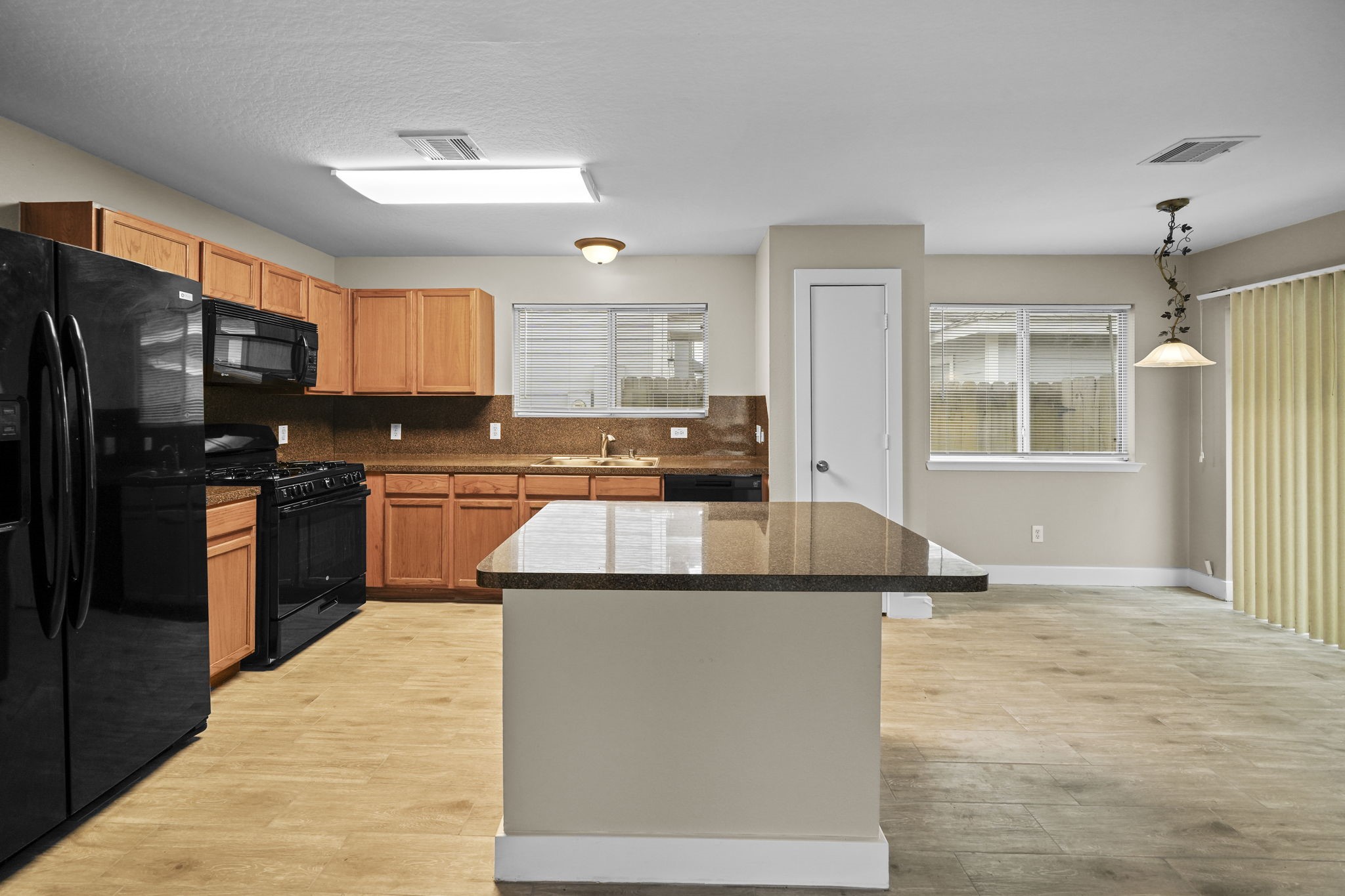 Kitchen island, providing additional countertop space or convenient area for bar stools.