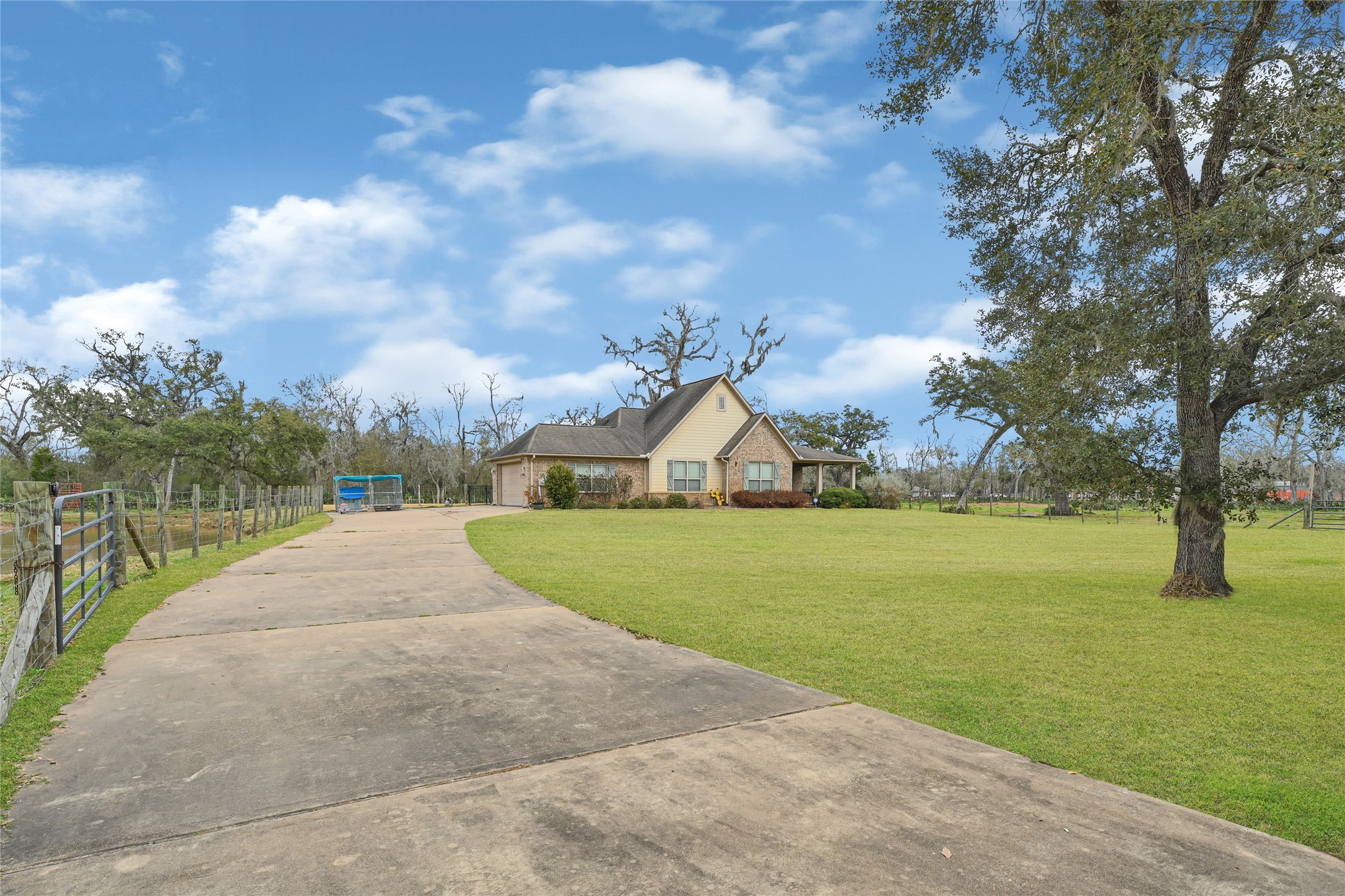 Extended private driveway offering a grand approach to the home while providing added privacy from the road and plenty of additional parking space for guests, RVs, or equipment.