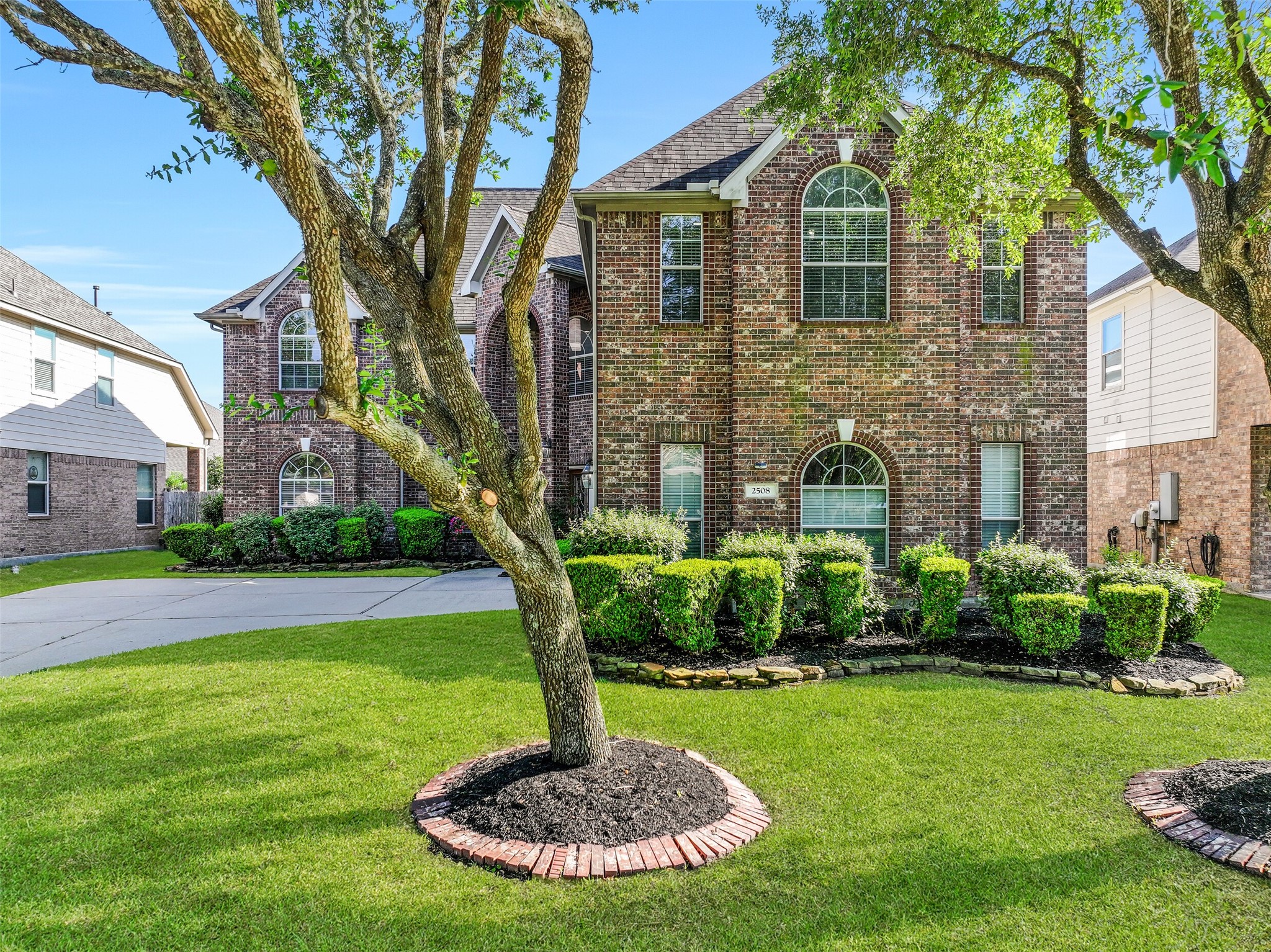 Welcome to 2508 Rockygate Lane in the Stonecreek section of Friendswood's sought-after West Ranch community! Nestled beneath mature shade trees, this impressive Village Builders home showcases a stately brick elevation, manicured landscaping, an in-ground sprinkler system, and fresh exterior paint for outstanding curb appeal.