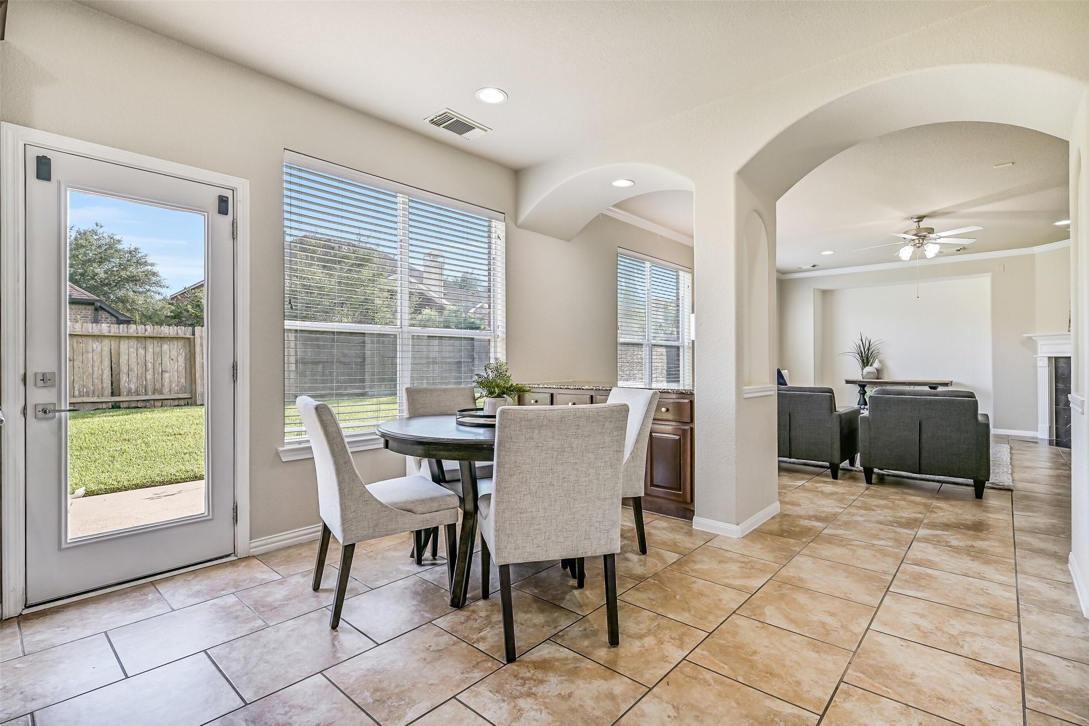 Another view of the breakfast room highlights the seamless connection to the family room and the built-in buffet tucked beneath the windows. Whether hosting a crowd or enjoying a quiet evening at home, this open-concept design offers the flexibility today's buyers are looking for.