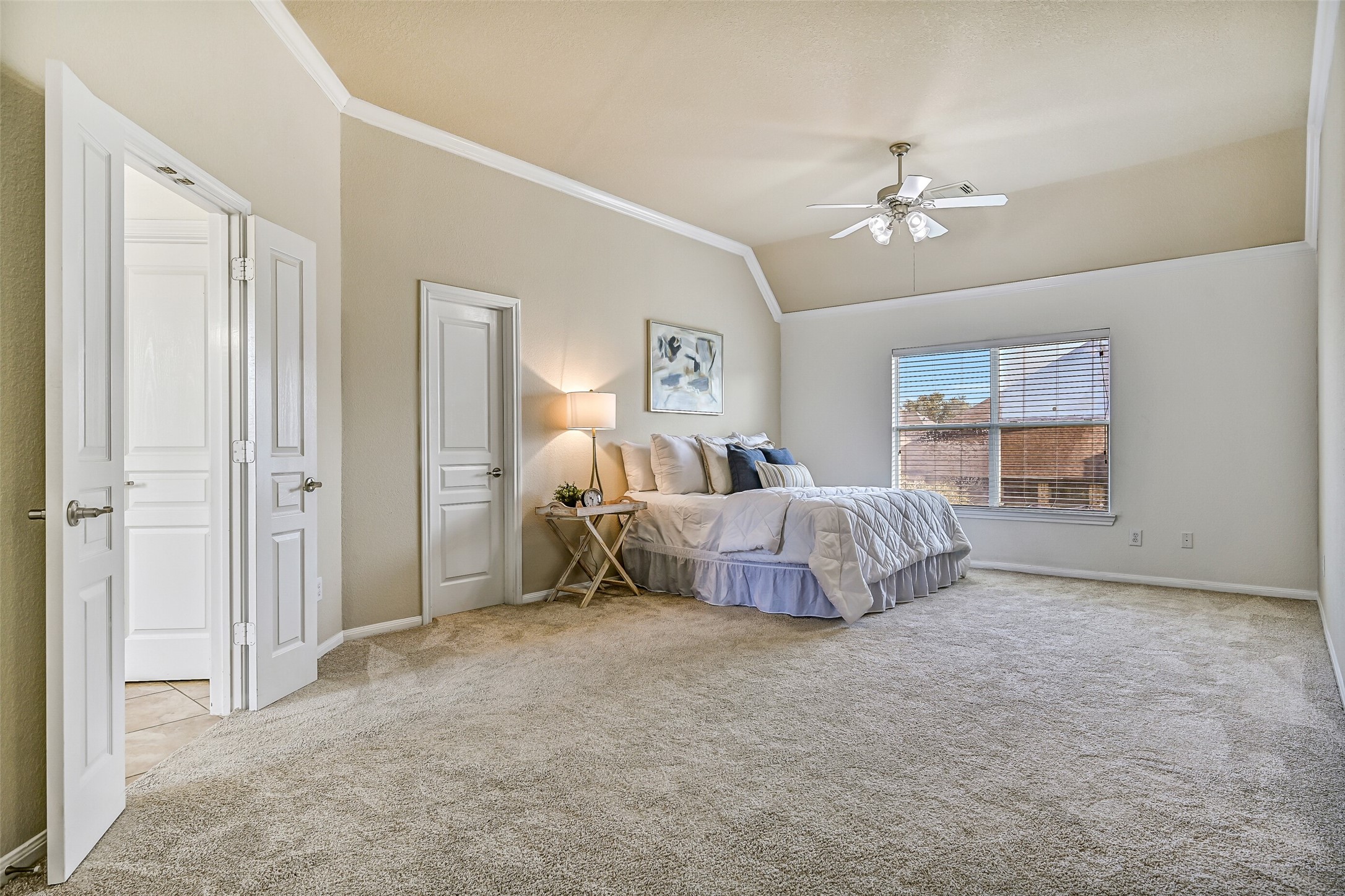 From this angle, appreciate the full size of the primary bedroom and its seamless connection to the adjoining sitting area. Fresh carpet and neutral finishes create a move-in-ready backdrop, while dual walk-in closets provide exceptional storage rarely found in homes at this price point.