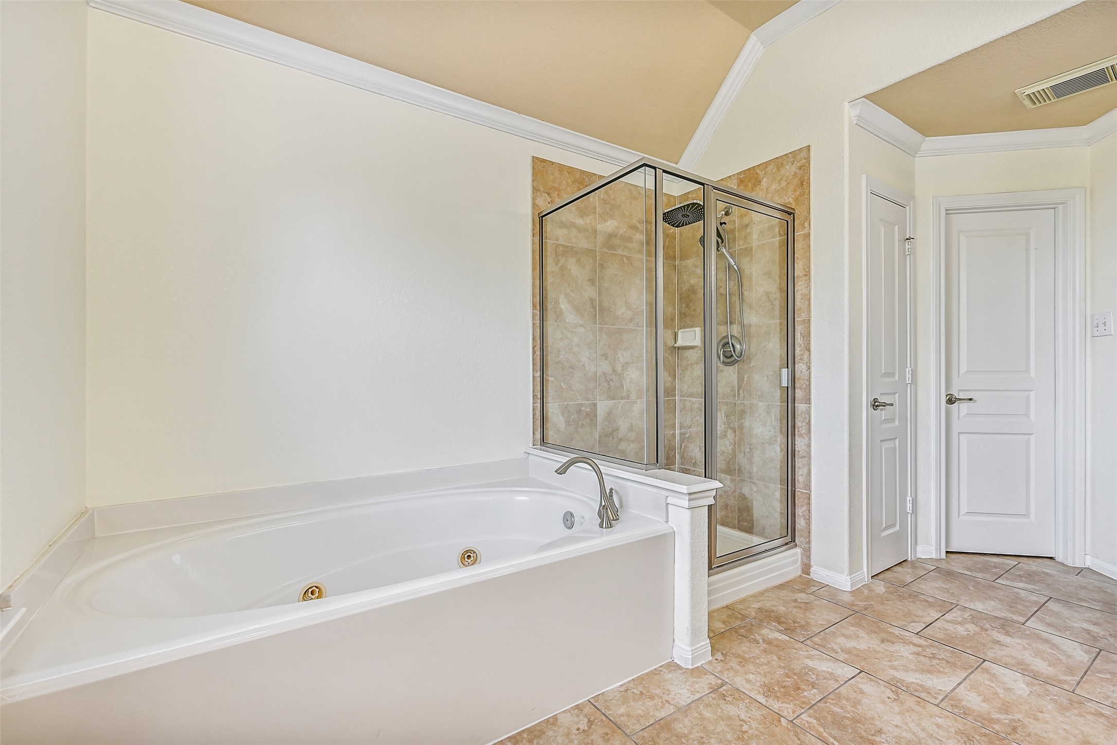 Relax and unwind in the jetted soaking tub or enjoy the separate glass-enclosed shower with a full tile surround. Combined with the spacious layout, dual closets, and vanity area, this bathroom delivers the comfort and functionality expected in a true owner's retreat.