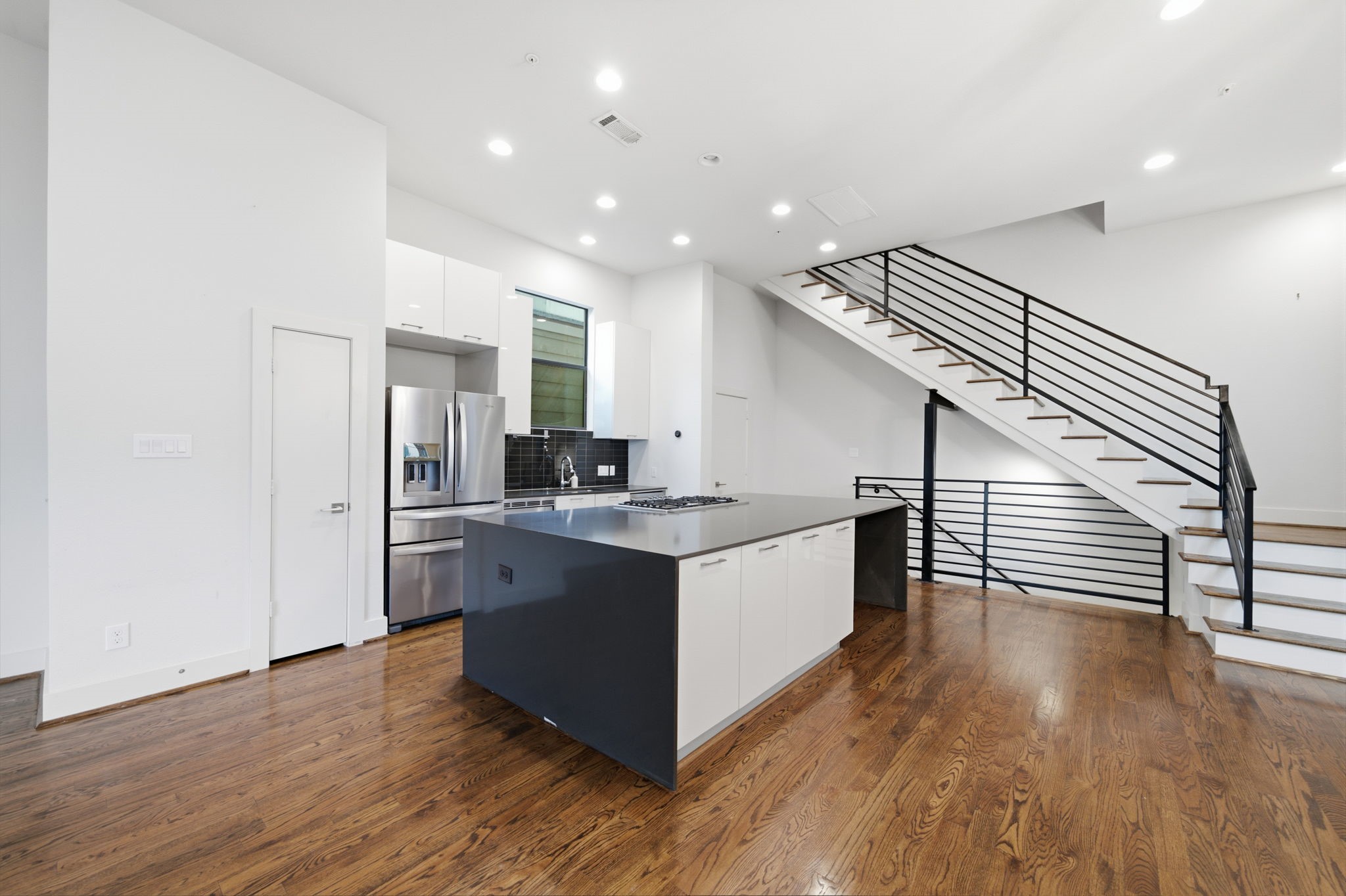 Note the WOOD floors throughout the home - NO CARPET! TALL CEILINGS!!