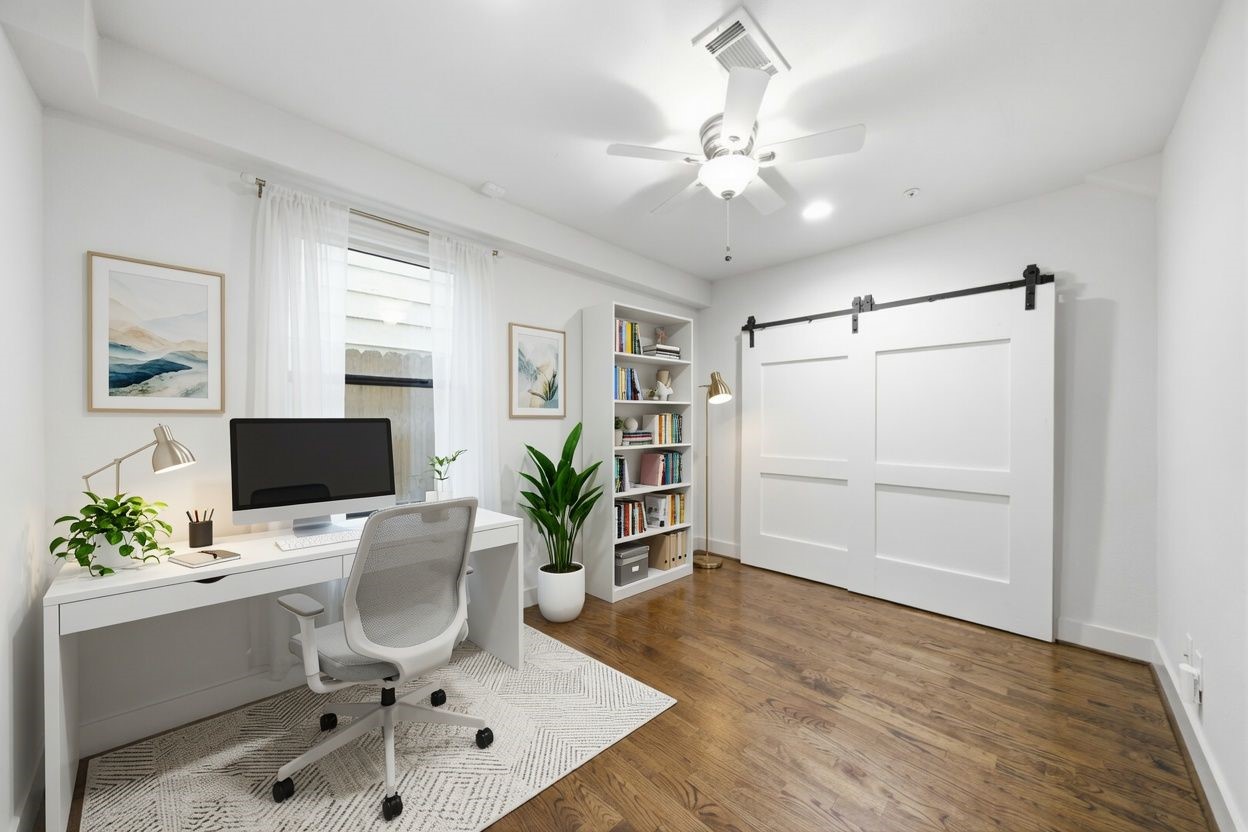 1st floor guest bedroom - virtually staged as an office. Good sized closet behind the sliding barn doors!