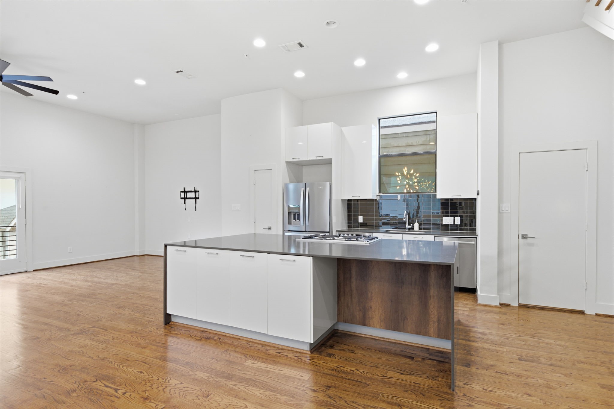 Door on the left (next to fridge) is the pantry. Door on the right is half bath for this floor - tucked away into a corner, but still conveniently close by!