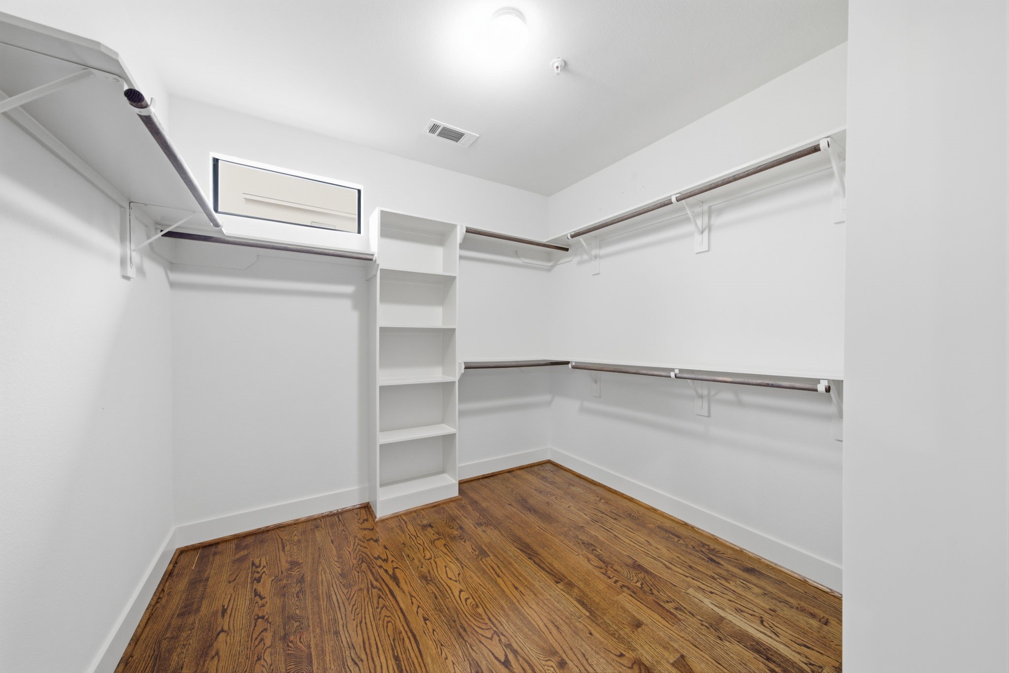 Primary Bedroom - LARGE WALK-IN CLOSET. Note WOOD floors continue on in here!