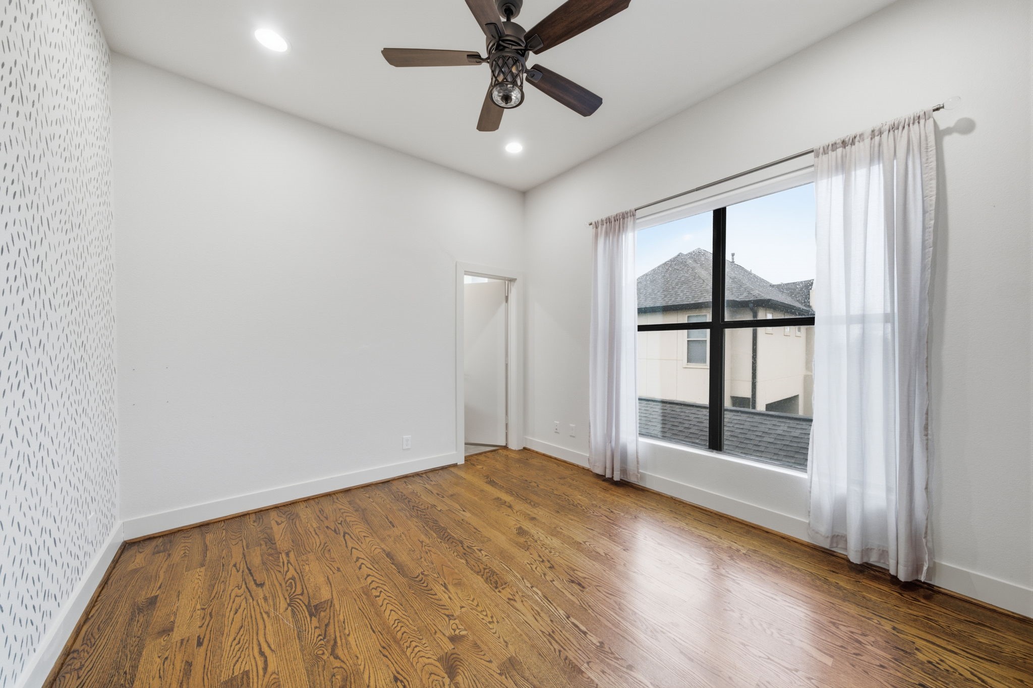 3rd floor - Guest bedroom. Hand painted feature wall on the left. LARGE WINDOWS on the right. Guest bathroom through the door