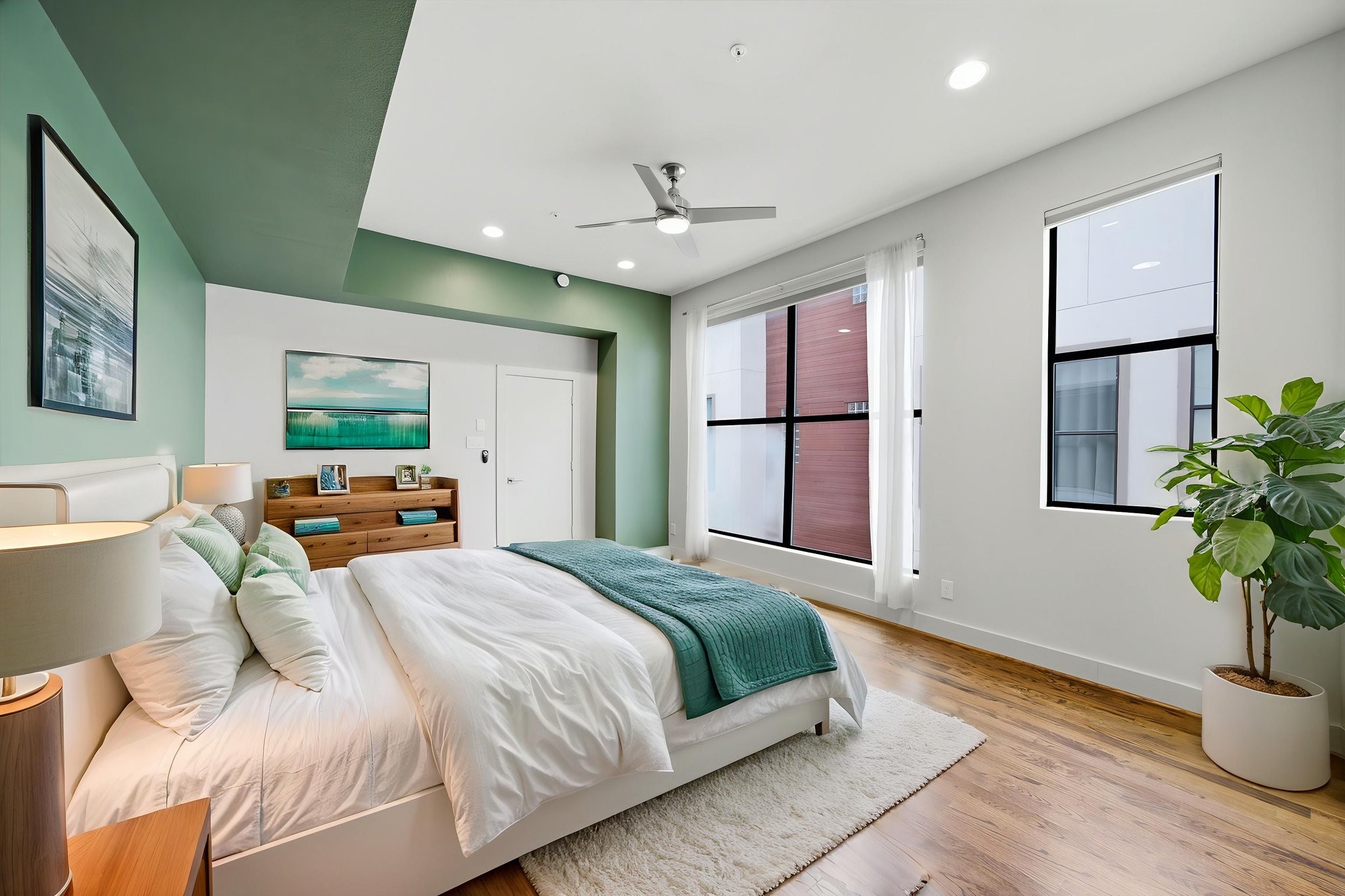 3rd floor - This is your Primary Bedroom OASIS! HUGE WINDOWS letting in so much natural light! Deep green paint and WOOD floors anchoring the space! Virtually staged