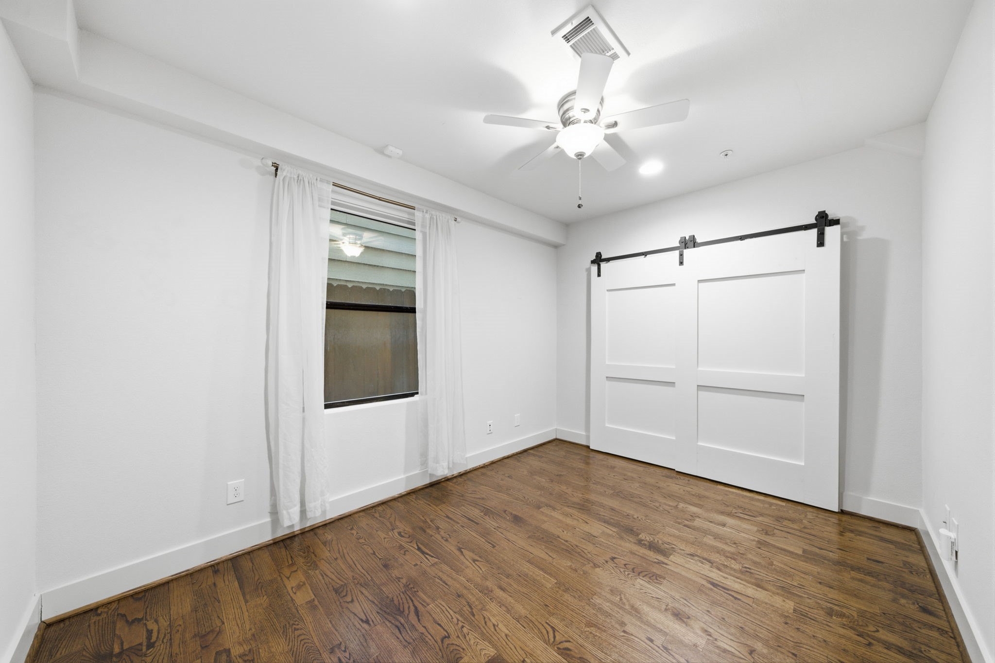 1st floor - Another guest bedroom down here. Good sized closet behind the sliding barn doors!