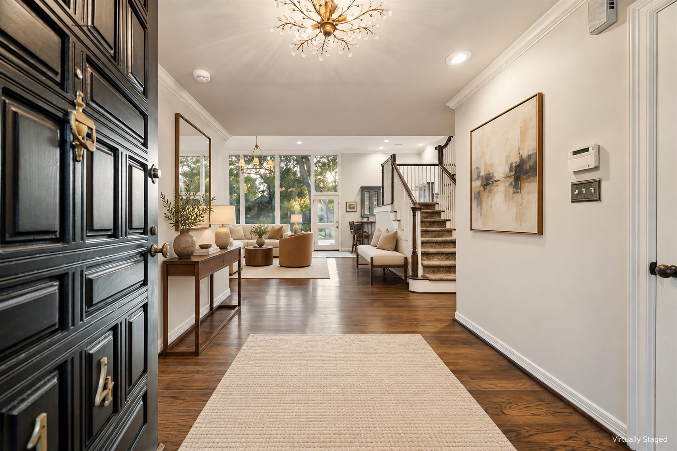 Virtually Staged - Warm oak flooring greets guests as their eyes are immediately drawn to the beautiful backyard via the wall of glass across the back of the home.