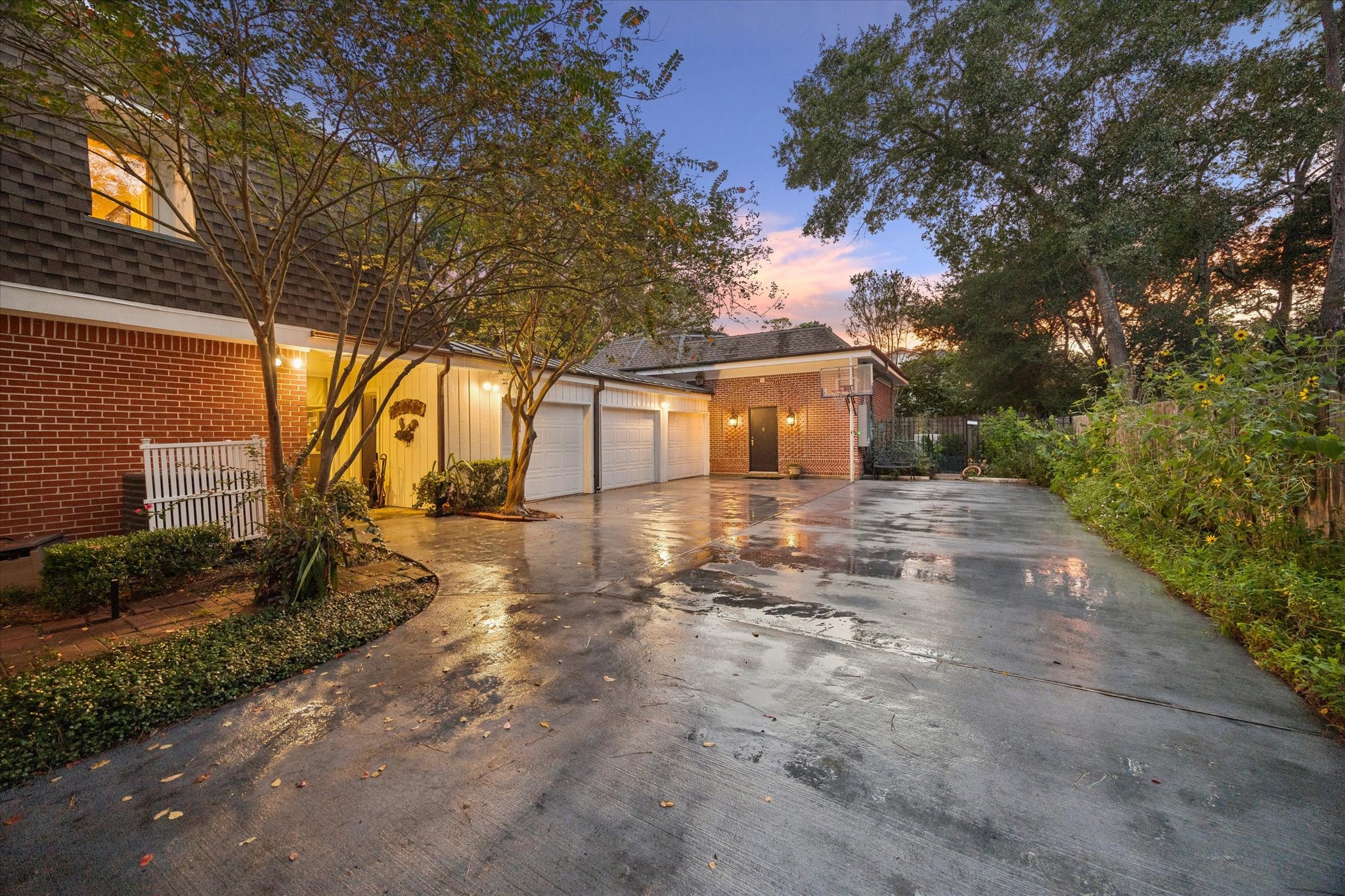 Gated motor court with 3-car garage, access to pool house, basketball goal and dog run behind the pool house.