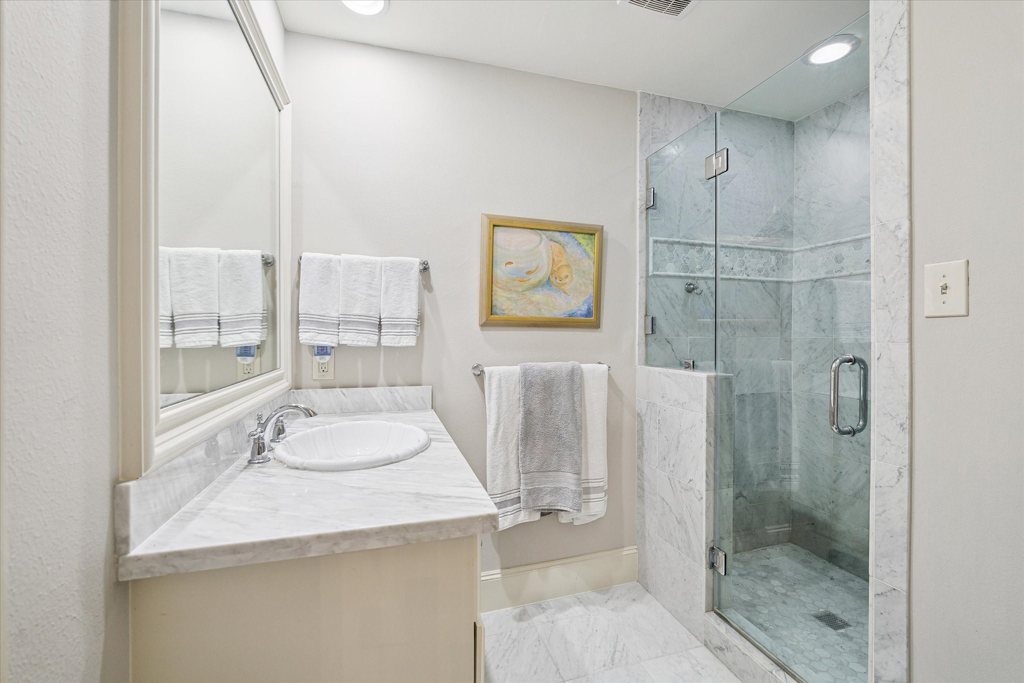 En suite bathroom adorned in arrara marble.