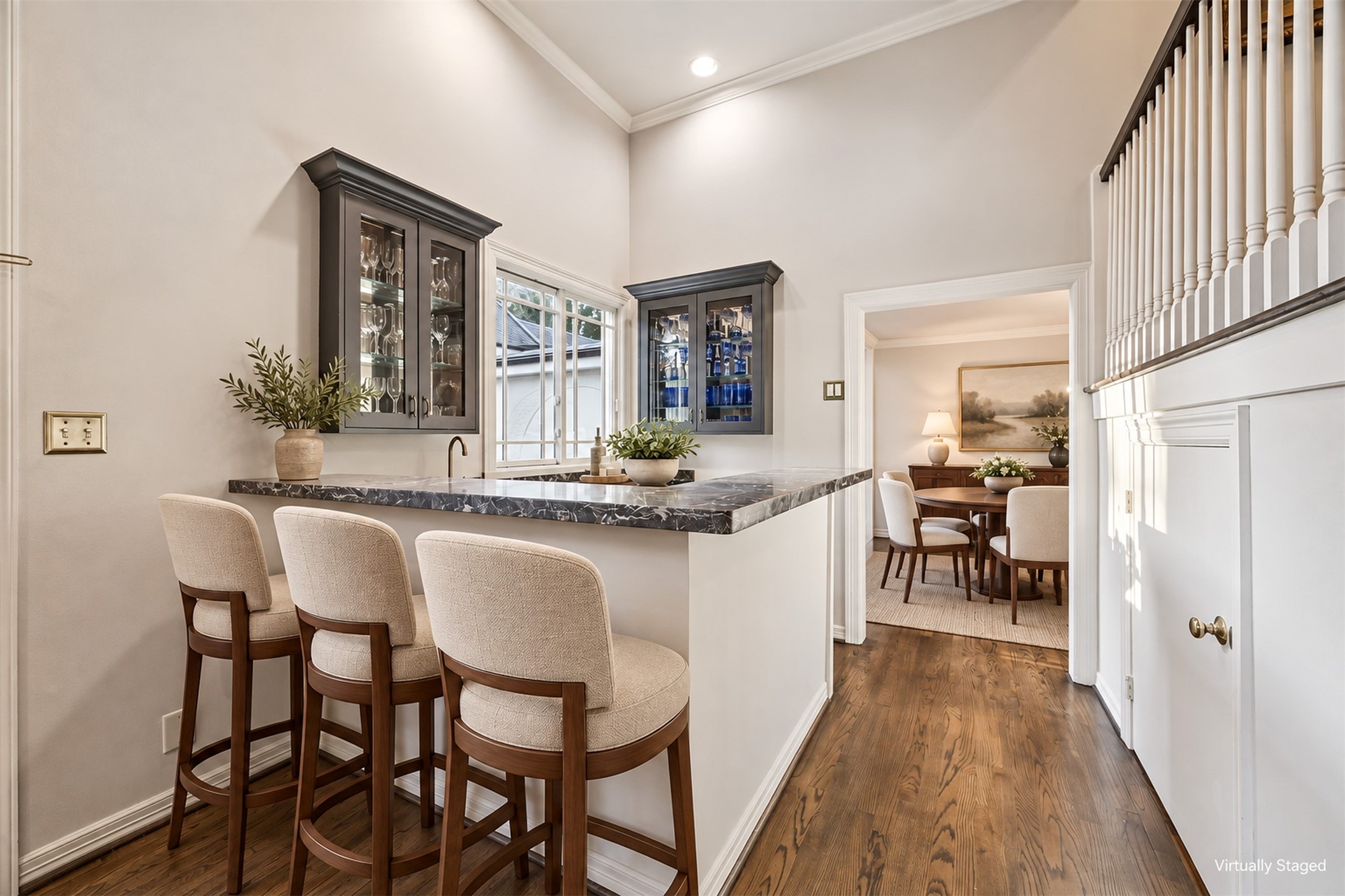 Virtually Staged - Wet bar seamlessly connects the living room and formal dining, perfect for entertaining in style.