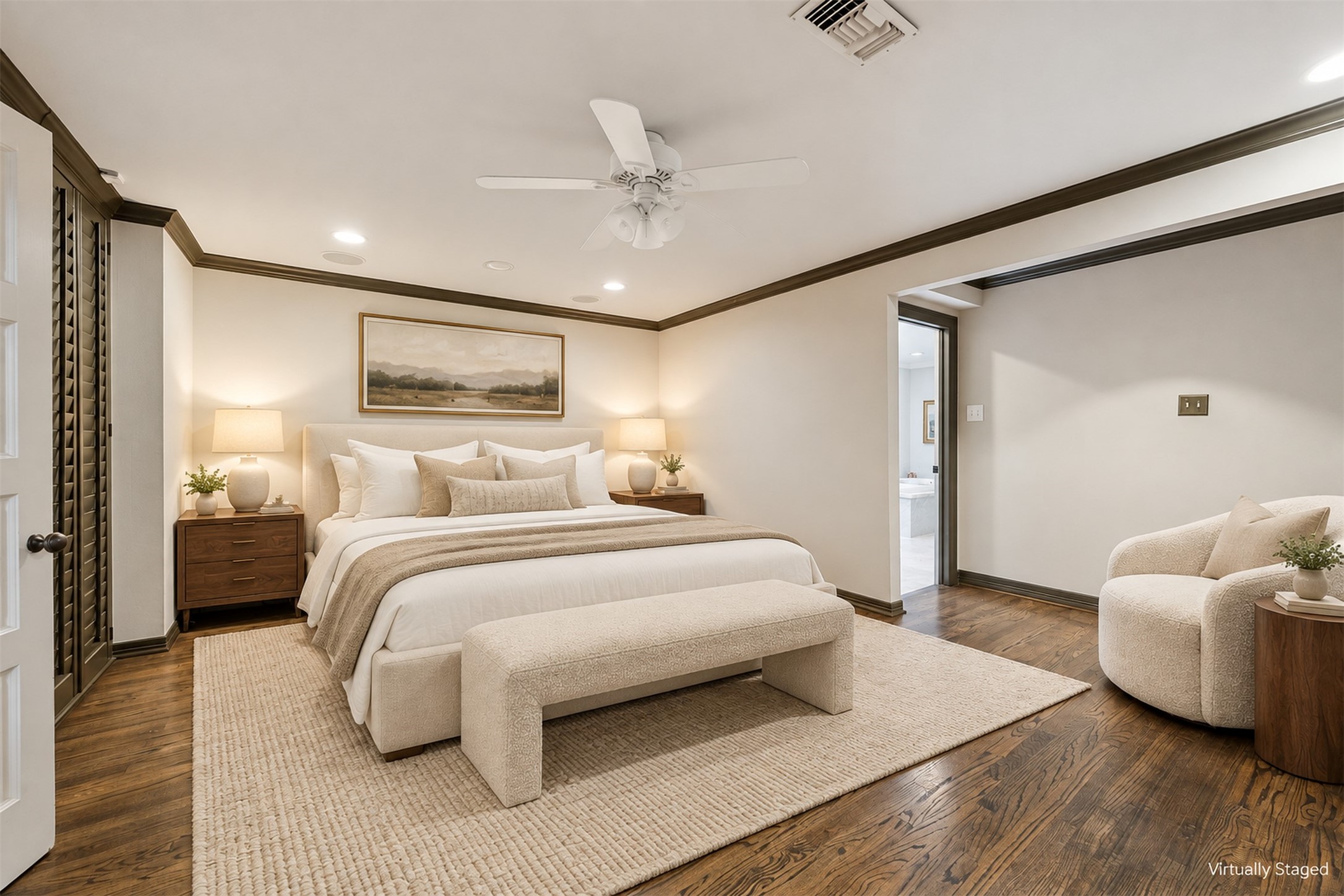 Virtually Staged - The primary bedroom features elegant built-in shelving, rich oak floors, and a serene ambiance great for relaxation.
