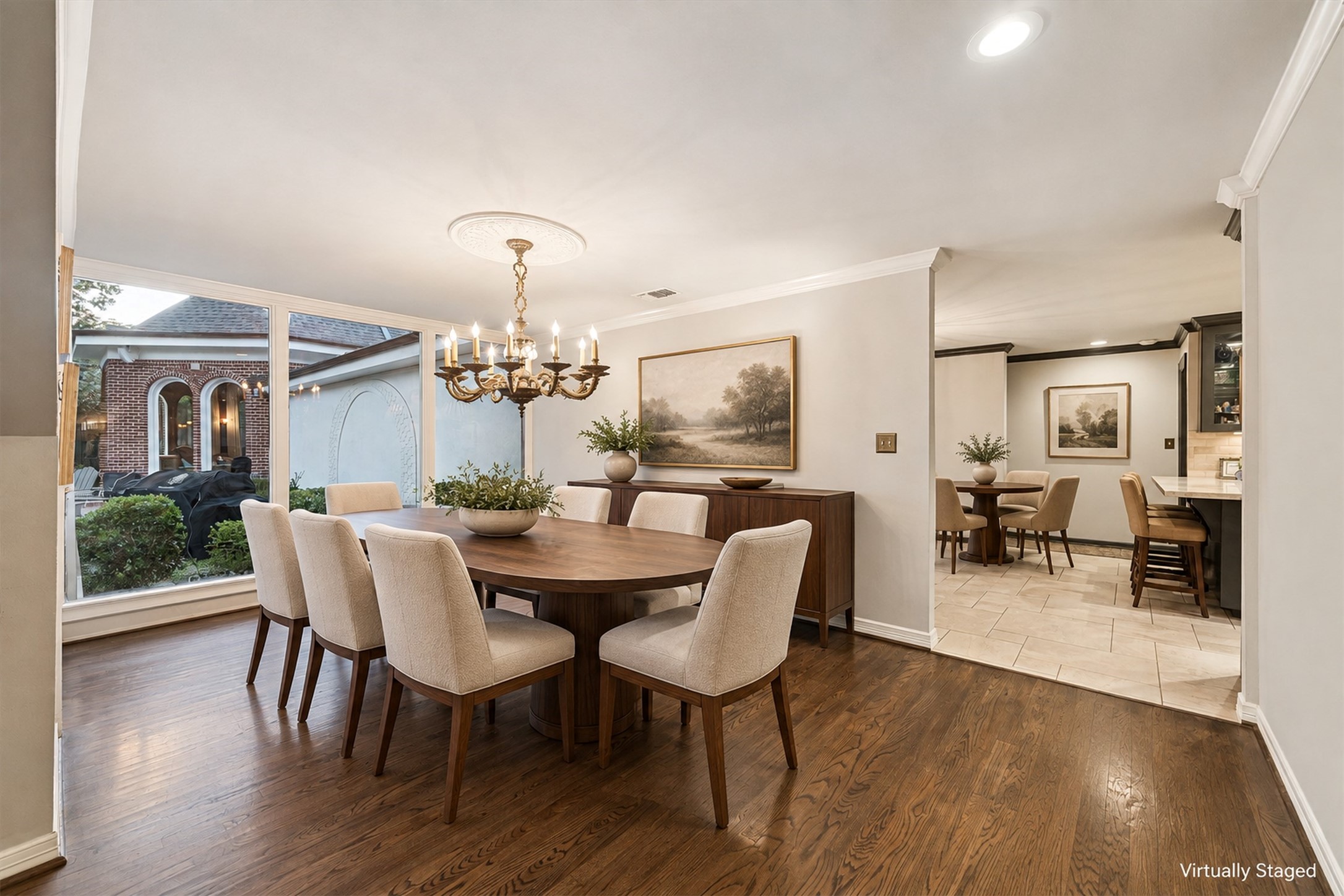 Virtually Staged - Formal dining room features an 1850's chandelier (excluded), solid oak flooring, and large windows offering a view of the charming backyard, perfect for hosting unforgettable gatherings.