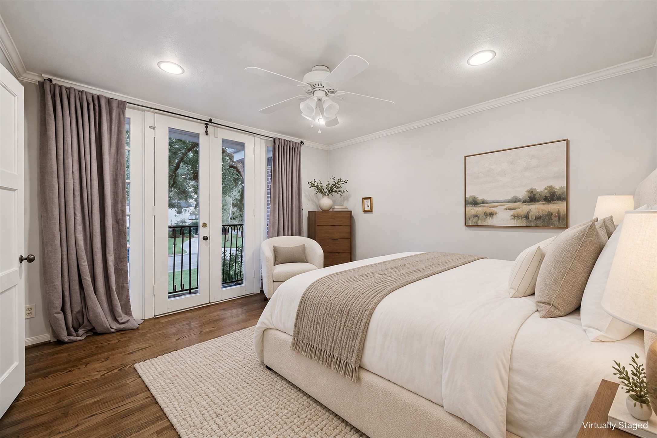 Virtually Staged - Secondary bedroom with oak floors and an en suite bathroom.