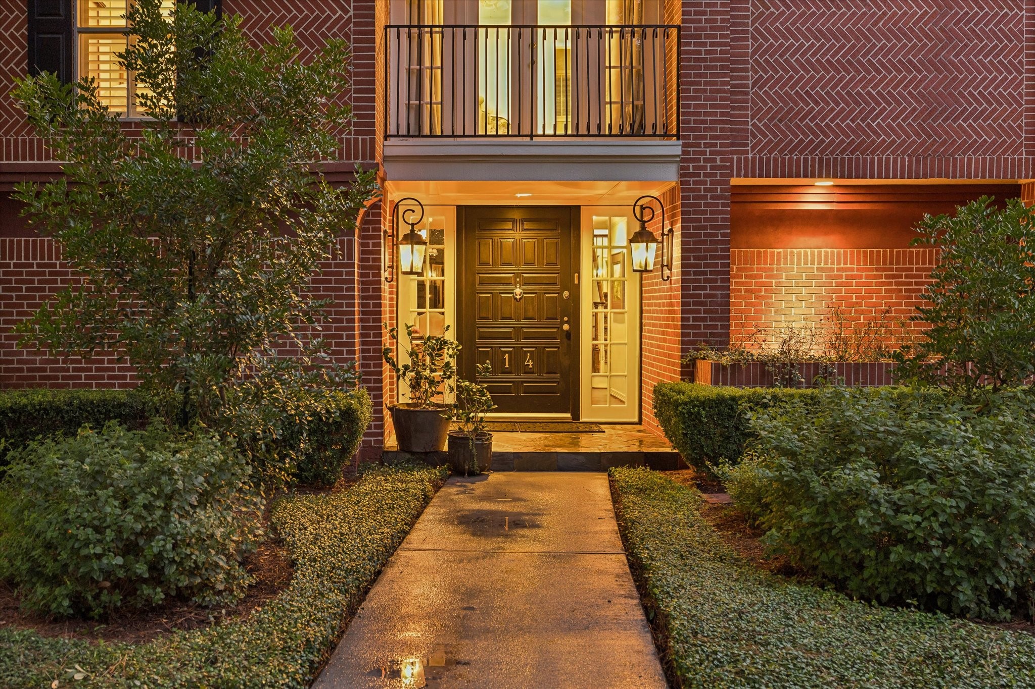 Elegant approach framed by balanced lighting and landscaping.