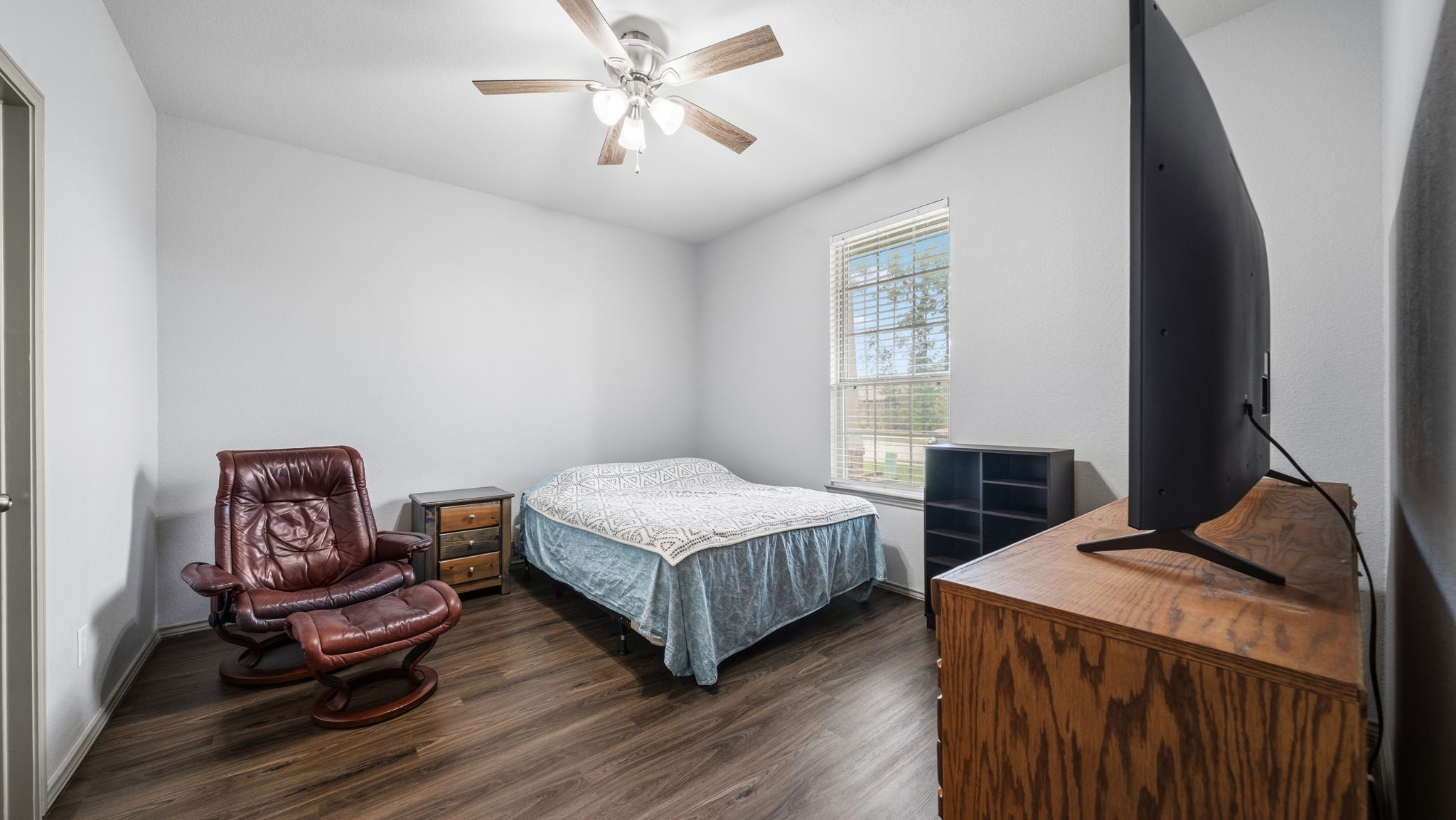 A rare find! This second primary bedroom near the front of the home offers a ceiling fan, walk-in closet, and plenty of room to make it your own.