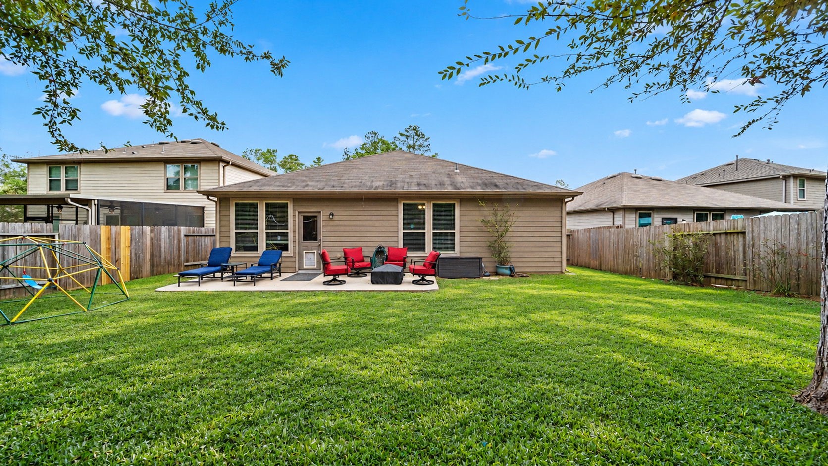 Step outside and unwind! The spacious backyard offers a concrete patio, plenty of green space, and a convenient dog door that staysperfect for your four-legged companion! Outdoor furniture and climbing structure not included.