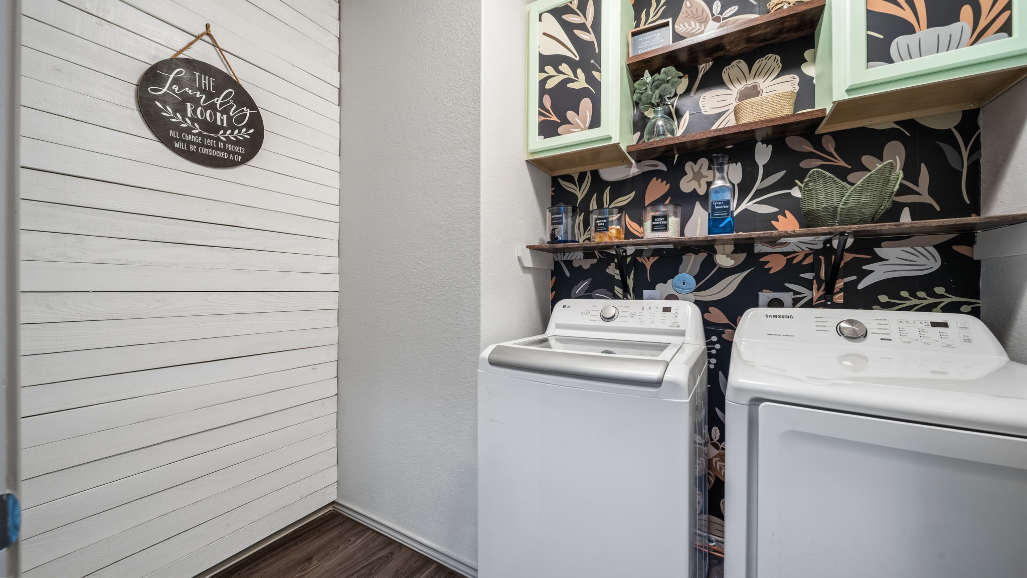 Laundry day just got easier! Enjoy a dedicated laundry room with full-size washer and dryer (included), stylish accent wallpaper, decorative shelving, and easy-care flooring.