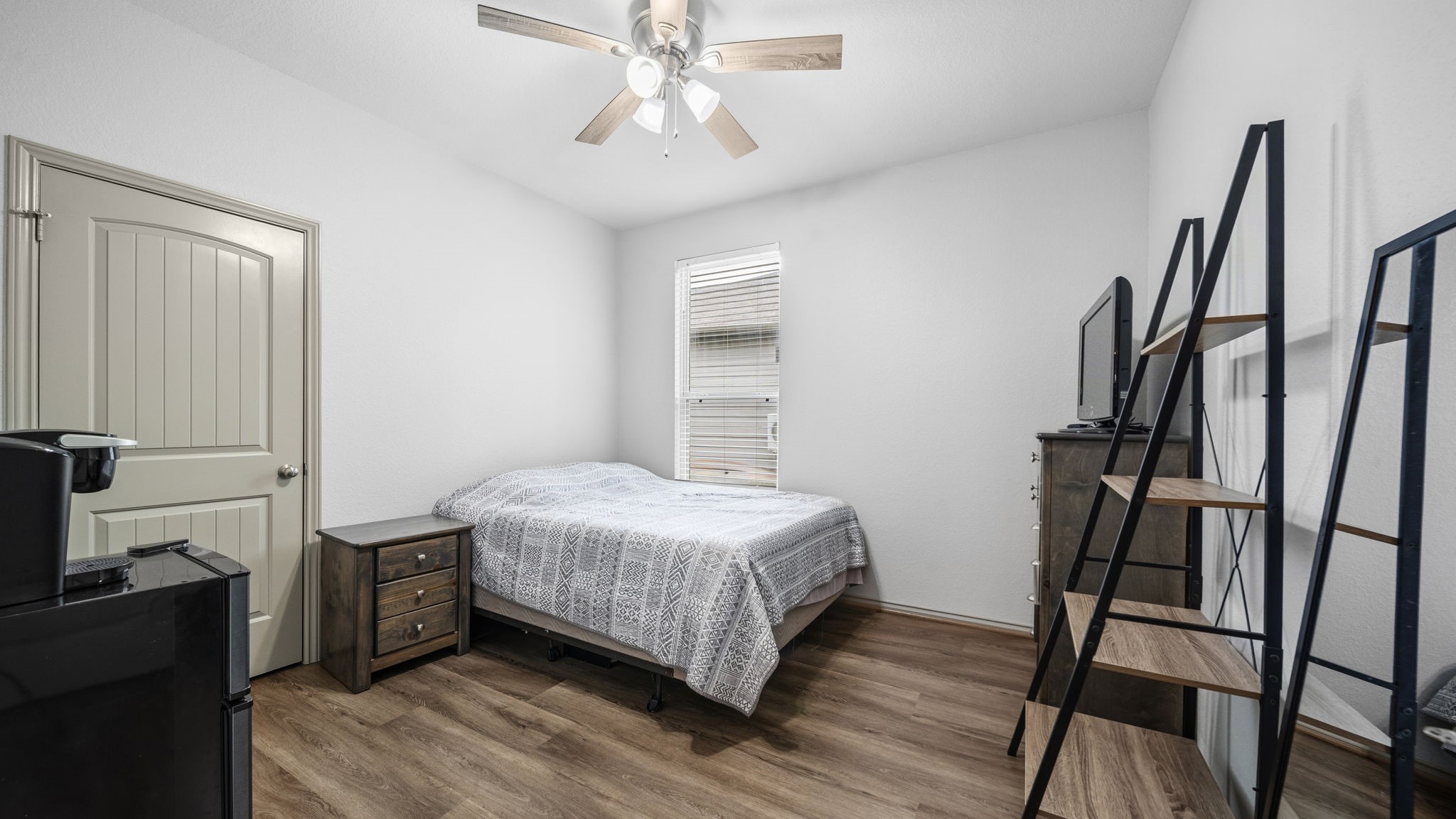 Another inviting bedroom with a ceiling fan, attractive flooring, and flexible space for your personal needs.