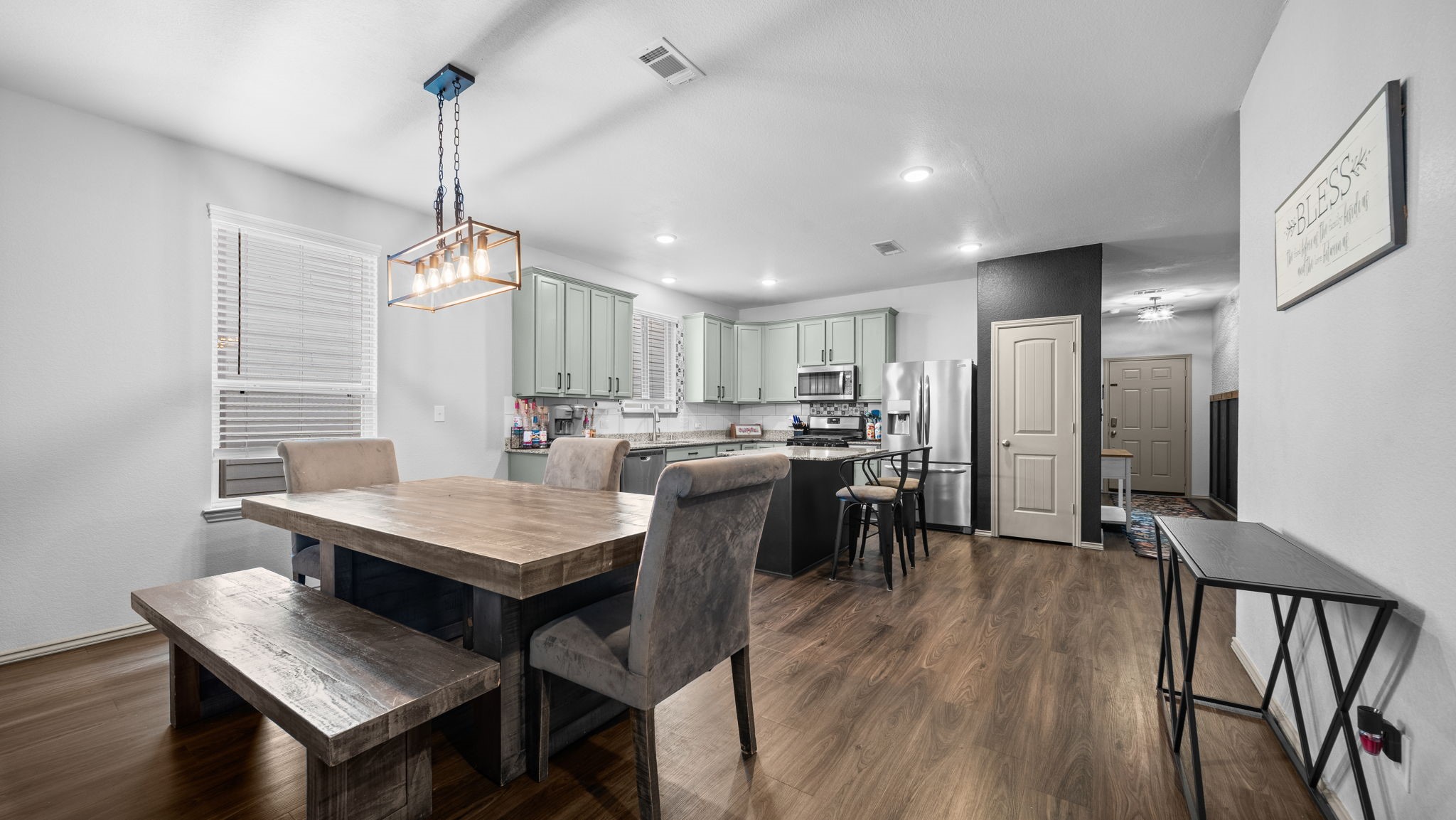 Gather around the table! This spacious dining area features a beautiful modern light fixture and an open layout perfect for everyday meals or entertaining. Gather around the table! This spacious dining area features a beautiful modern light fixture and an open layout perfect for everyday meals or entertaining.