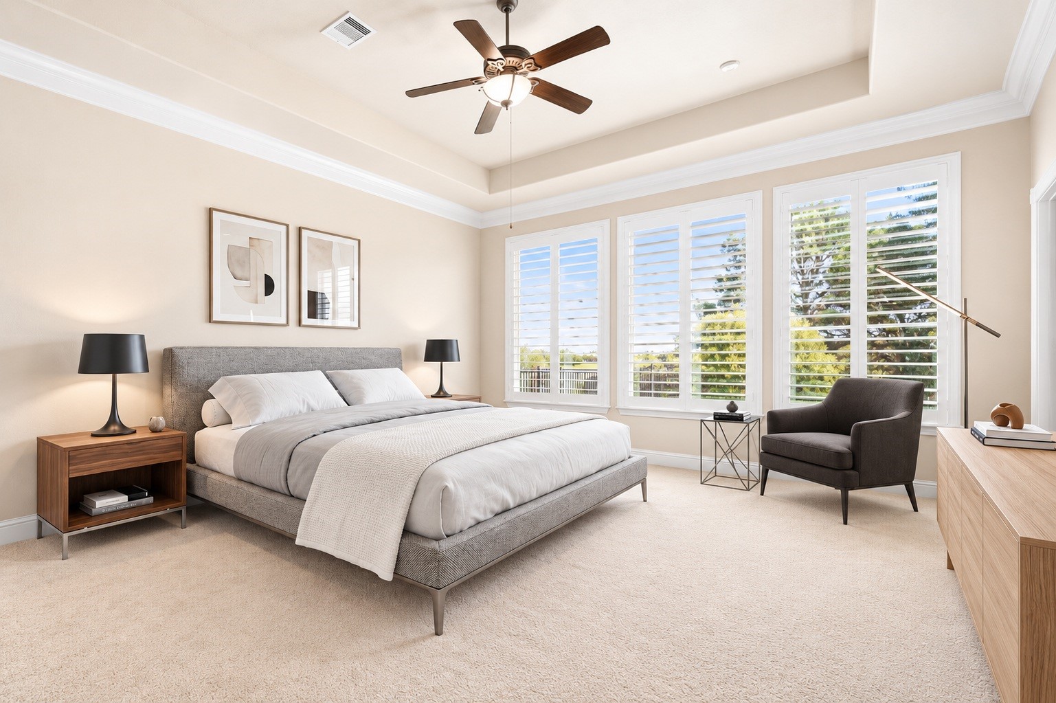 The primary suite offers a peaceful retreat, framed by a tray ceiling and a wall of windows overlooking the backyard. Virtually staged.
