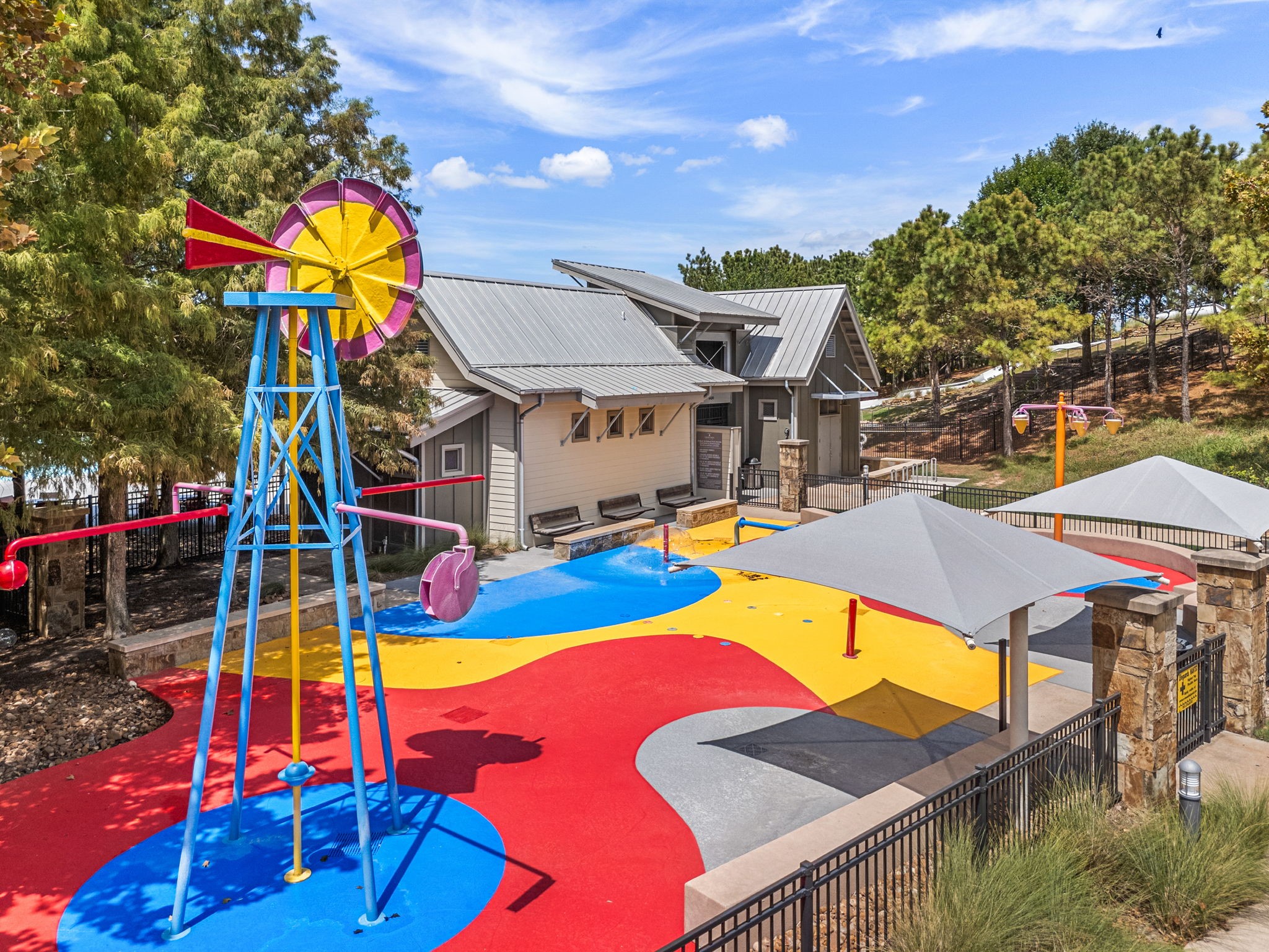 In Cross Creek Ranch in Fulshear, this colorful splash pad features a windmill-inspired water feature, ground sprays, shaded play areas, and nearby seatingan inviting place for residents to cool off during warm Texas days.