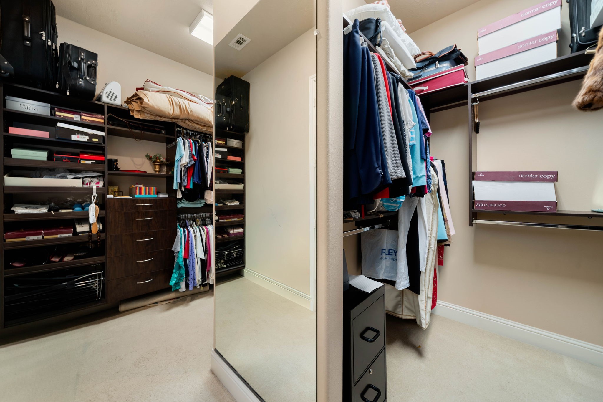 The primary closet offers generous built-in shelving and hanging space for effortless organization.