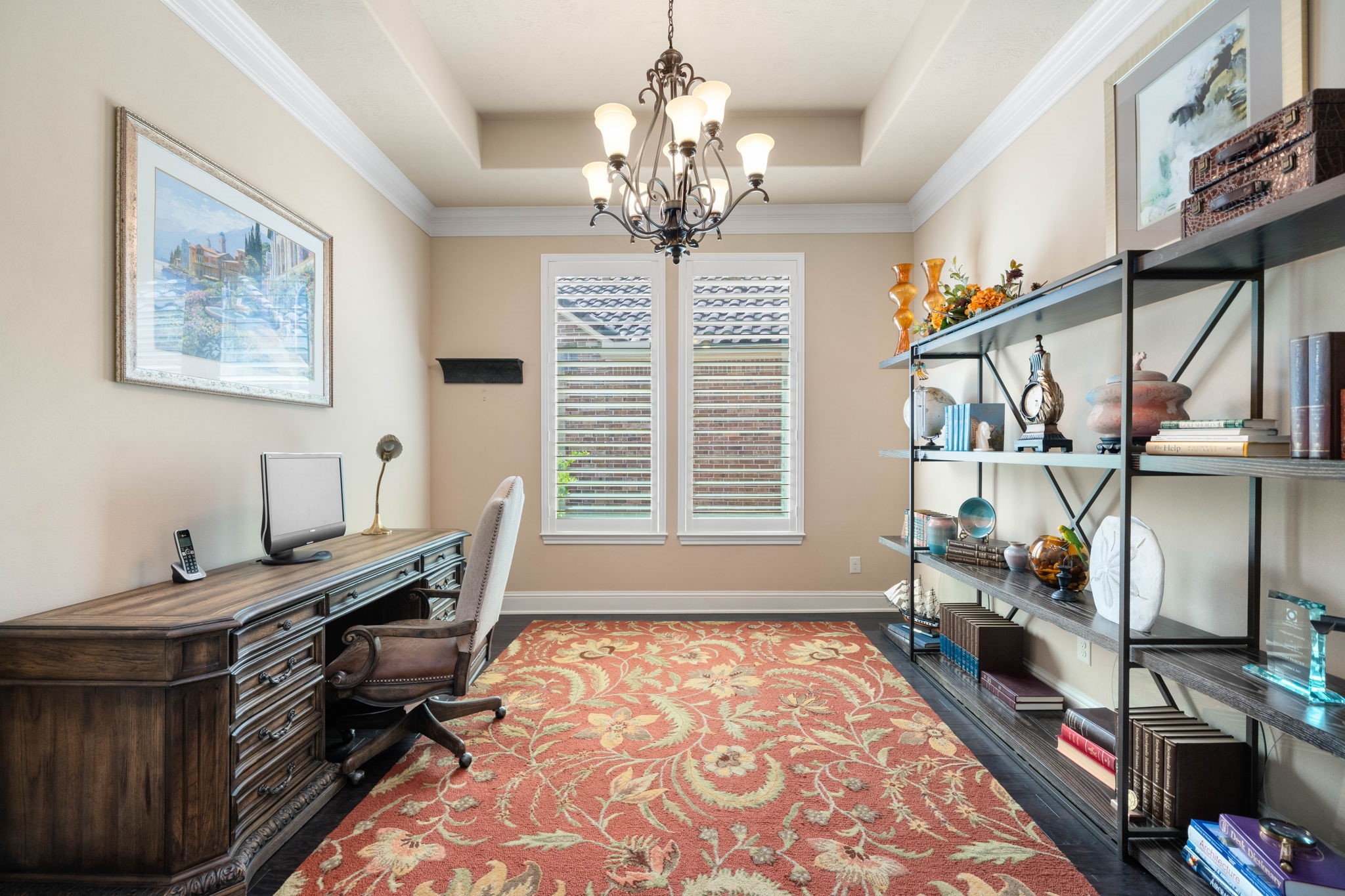 A private home office offers a quiet retreat, complete with a tray ceiling and custom built-in shelving.