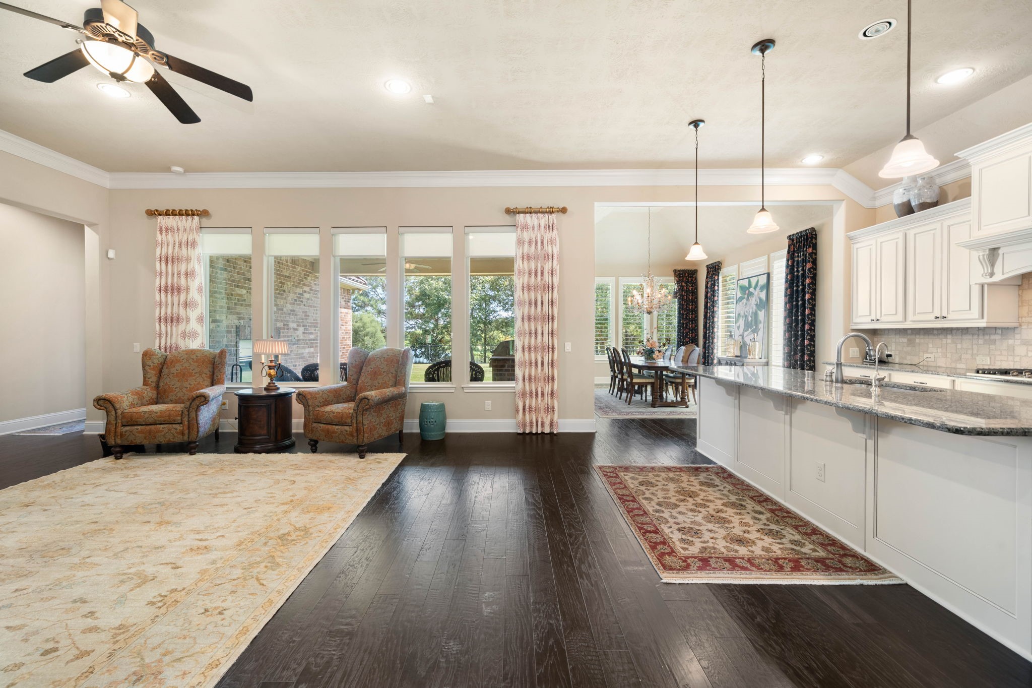 Wired for sound and finished with dark hardwood floors throughout, the open living area flows effortlessly into the kitchen and dining space.