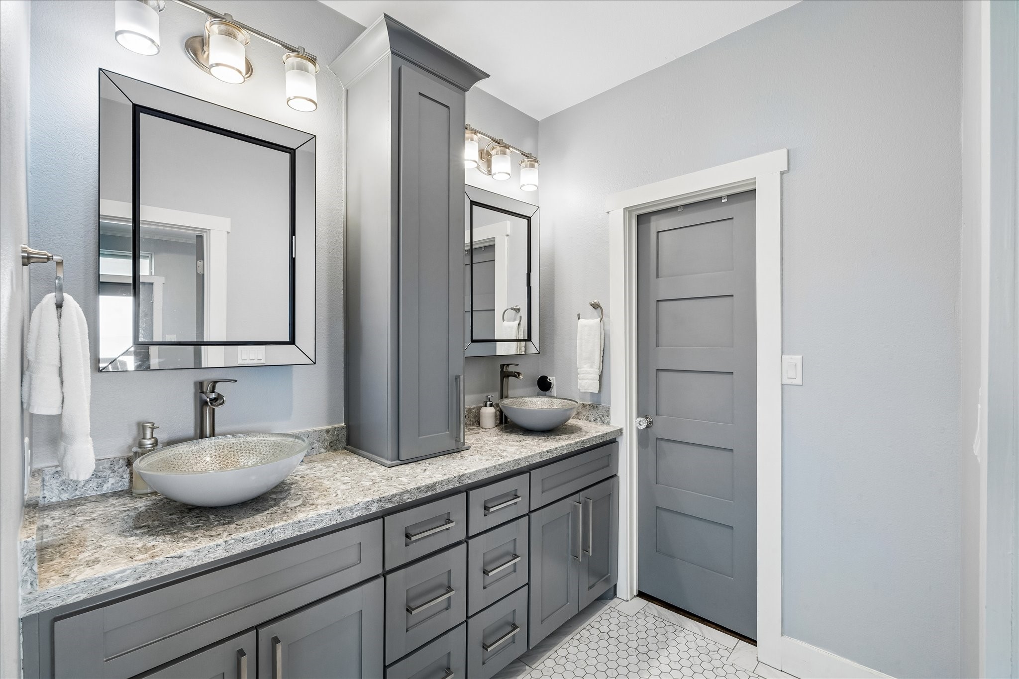 Primary bath with heated floors and his/her walk-in closets