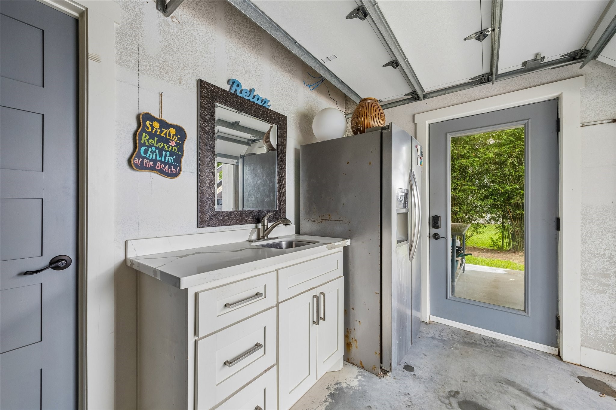 Pool bath, sink and full refrigerator in garage