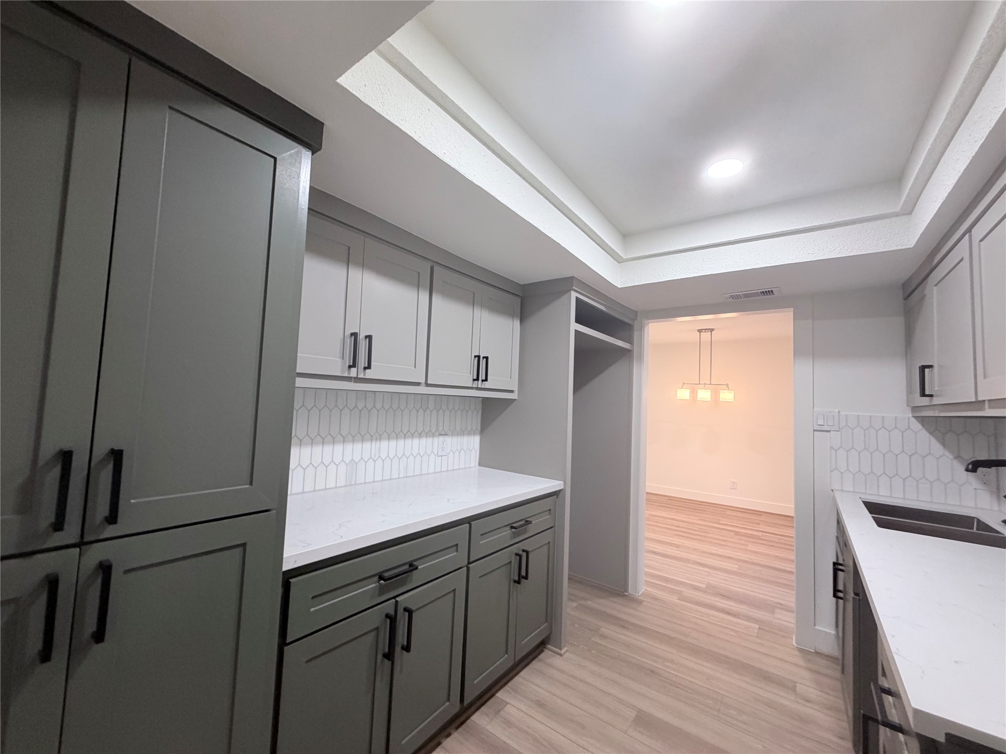 Looking into your dining room, add counter space features Quartz and custom cabinets for extra sotrage.