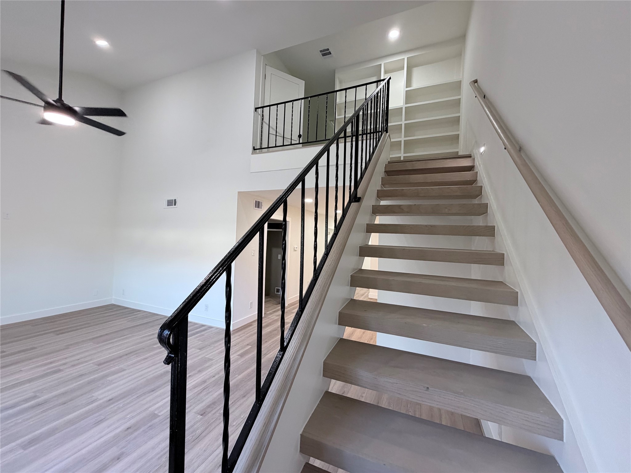 Stairs have been reimagined to be modern, open and a raised stair rail for extra security.