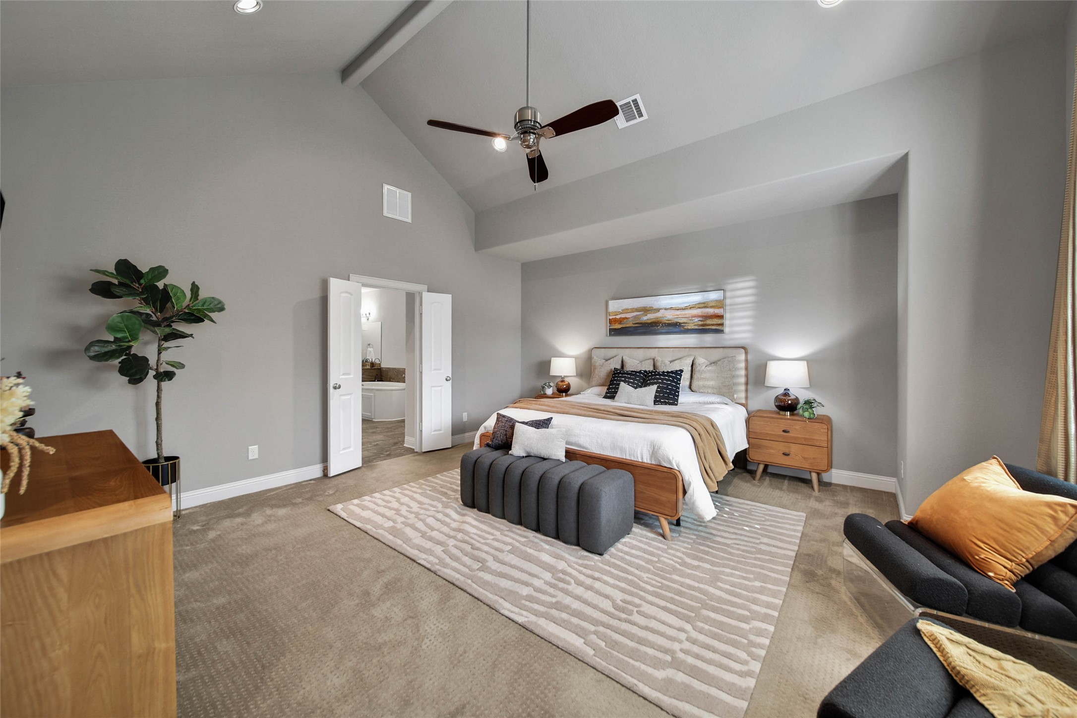 Spacious primary bedroom with vaulted ceilings