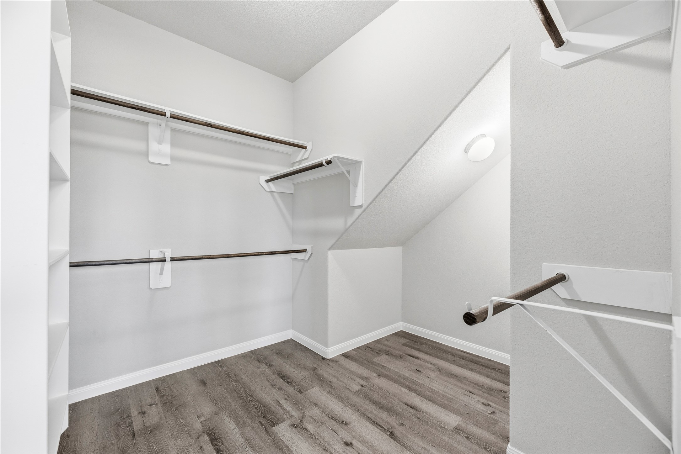 Generous walk in closet with built in shelving.