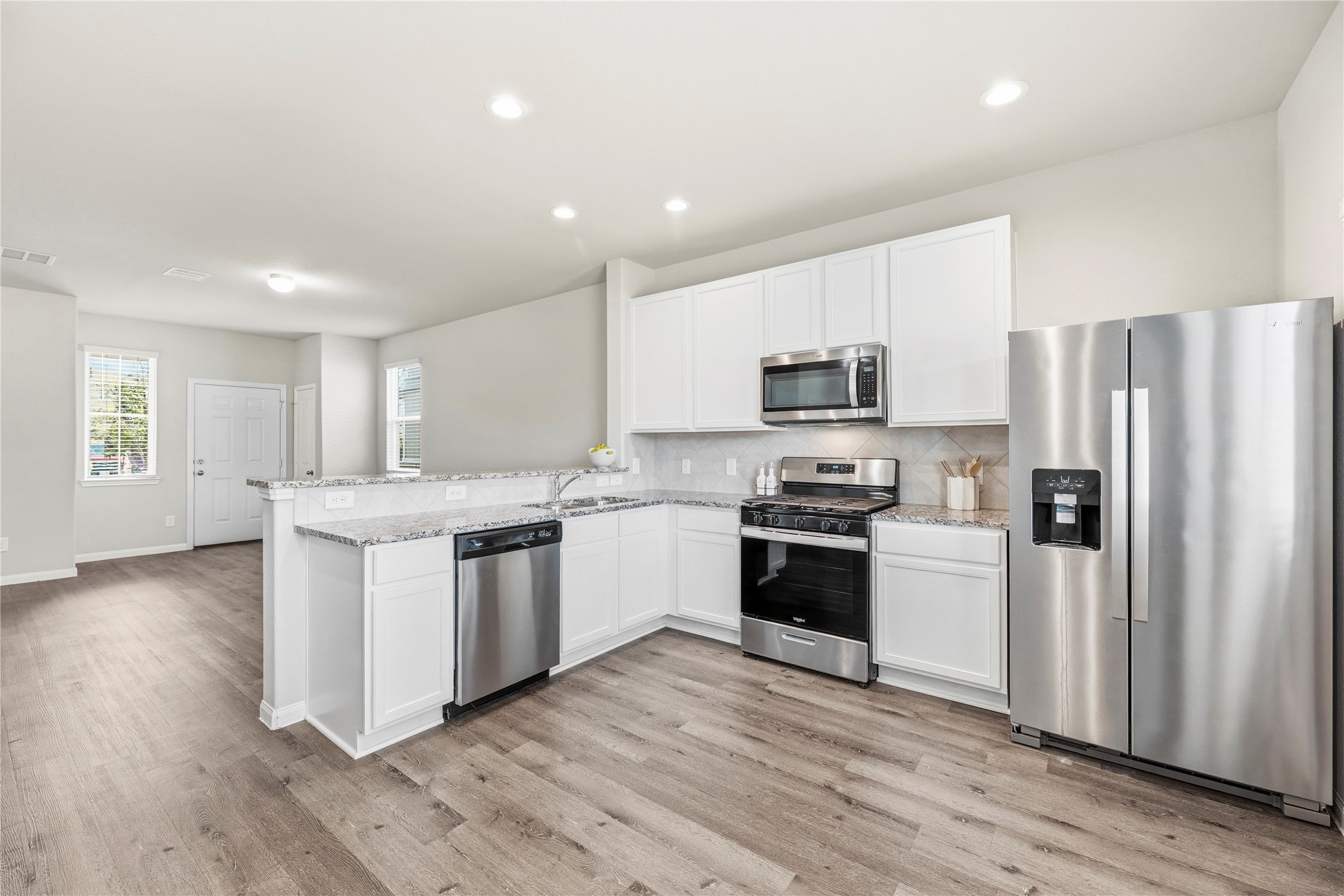 Kitchen with granite counters and stainless appliances.  Refrigerator included.