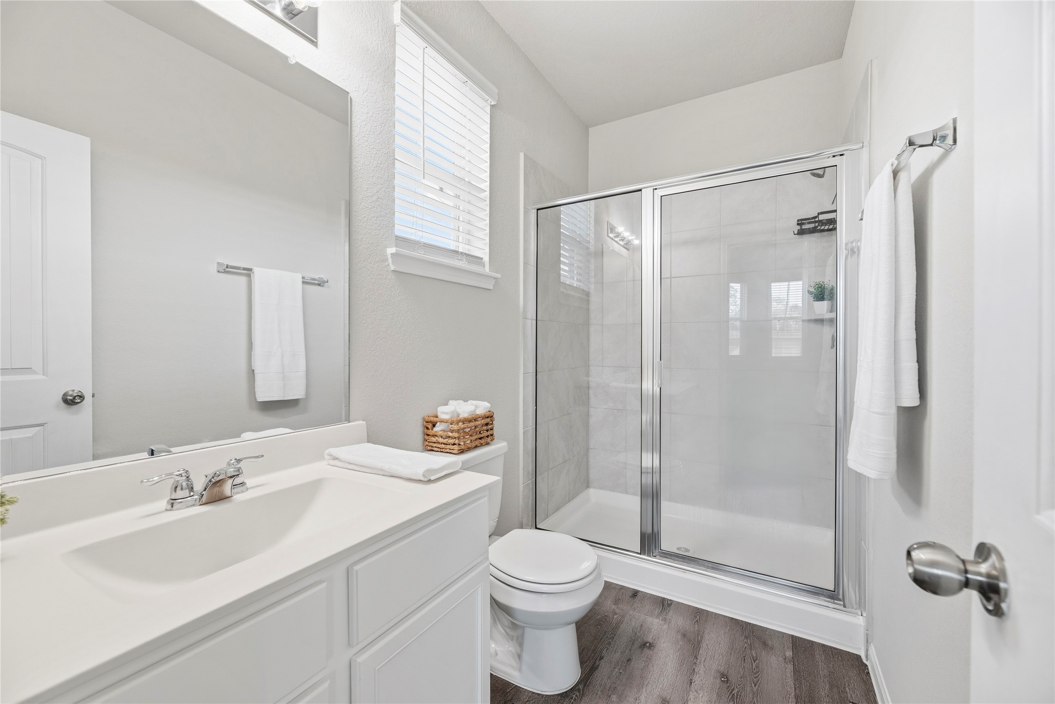 Primary bath with tiled shower and natural light