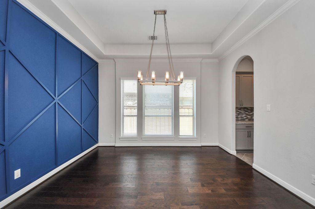 Formal dining room with dramatic accent wall.