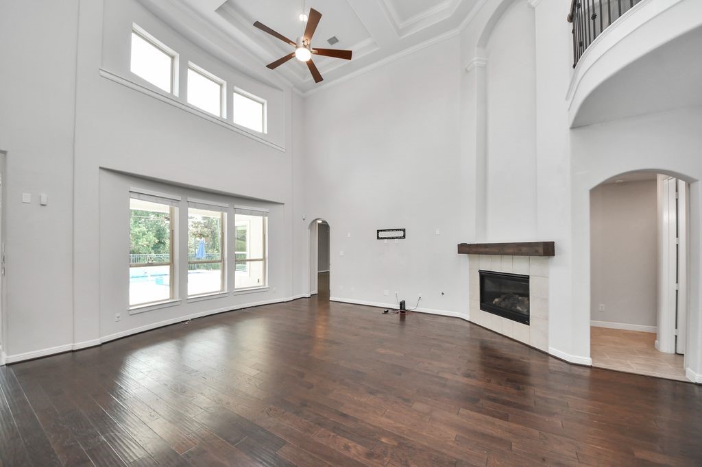 This family room is amazing! High ceilings, designer fan, gas log fireplace, & open to the kitchen and breakfast room. Great views of the pool/spa and greenbelt behind.