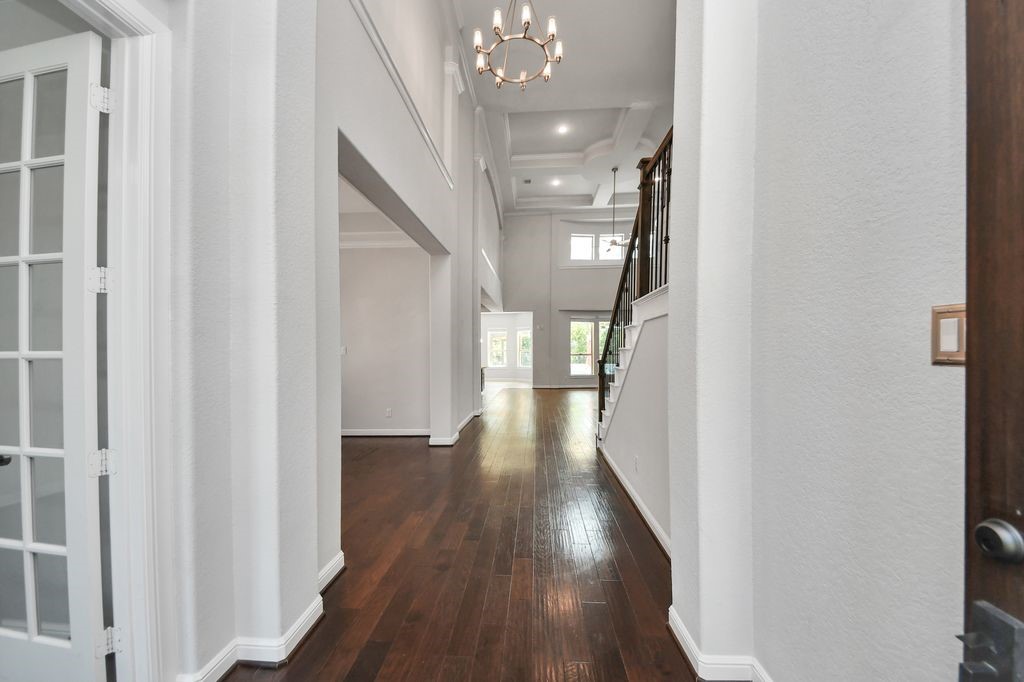 2 story entry with tray ceiling & a chandelier.