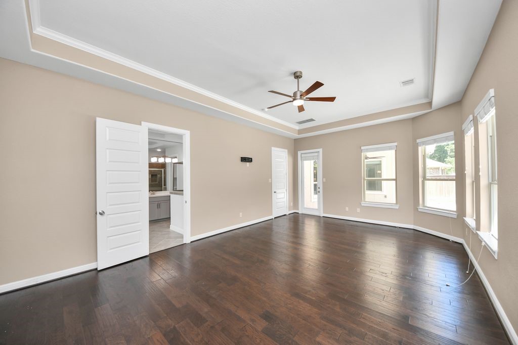The primary suite has private access to the covered back patio and pool area.