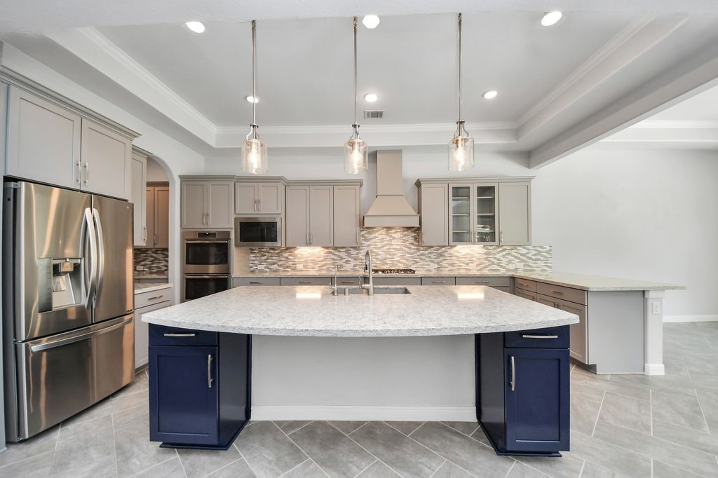 Huge island /breakfast bar offers additional casual seating.
