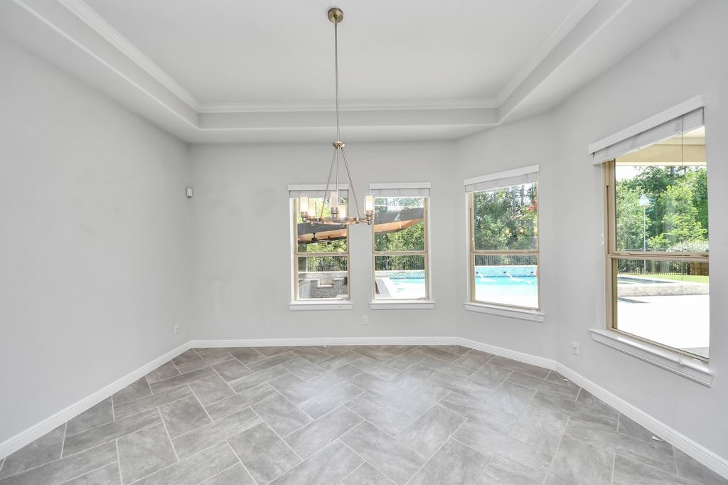 Breakfast room with views of the pool, covered culinary center & greenbelt.