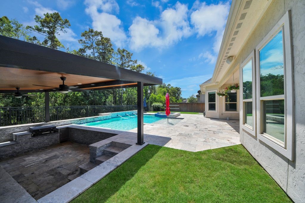 View from the sunken covered culinary area, including a Blackstone grill & ceiling fan.