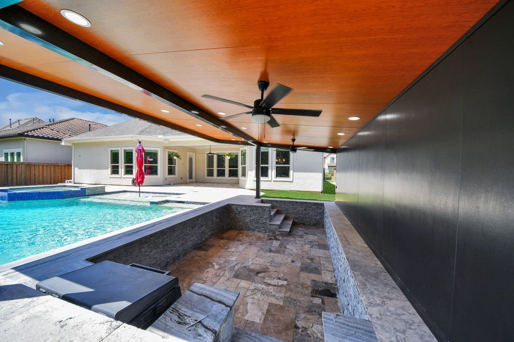 This amazing, covered area has a swim up counter from the pool with resort style pool seating!